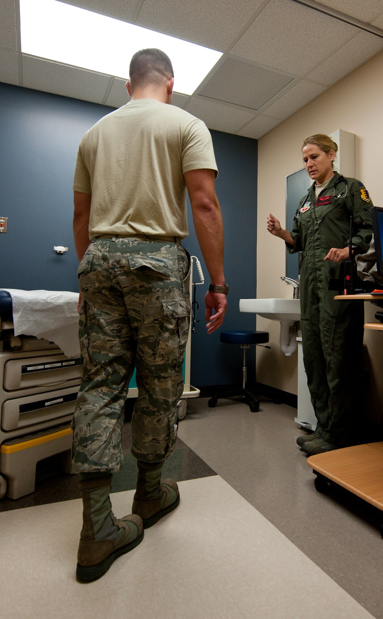 Capt. Sarah Freidel, 34th Bomb Squadron flight surgeon, analyzes Staff Sgt. Jacob Appleby, 28th Medical Operations Squadron ambulance services technician, while he performs exercises during a physical exam in the flight medicine clinic on Ellsworth Air Force Base, S.D., May 2, 2012. Various tests are performed during the exam to ensure that all of the Airmen assessed are able and ready to perform their highly-stressful duties. (U.S. Air Force photo by Airman 1st Class Kate Thornton/Released)