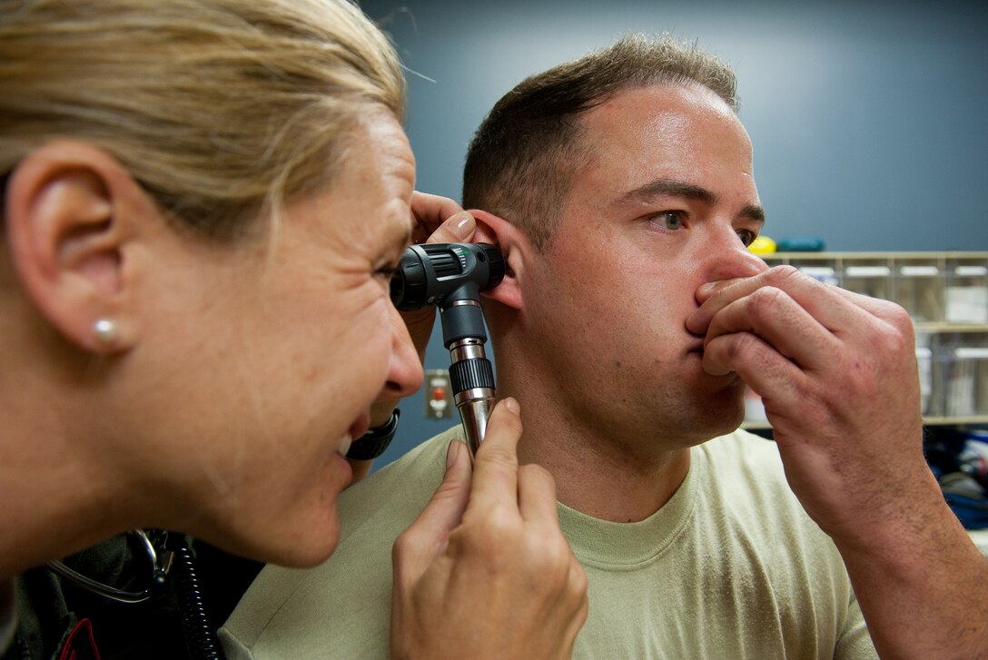 Capt. Sarah Freidel, 34th Bomb Squadron flight surgeon, performs a valsalva maneuver on Staff Sgt. Jacob Appleby, 28th Medical Operations Squadron ambulance services technician, during a physical exam in the flight medicine clinic on Ellsworth Air Force Base, S.D., May 2, 2012. During a valsalva maneuver, medical professionals watch closely as the patient exhales against a closed airway and evaluate how well the patient’s ear drum moves to better determine the patient’s ear health. (U.S. Air Force photo by Airman 1st Class Kate Thornton/Released)
