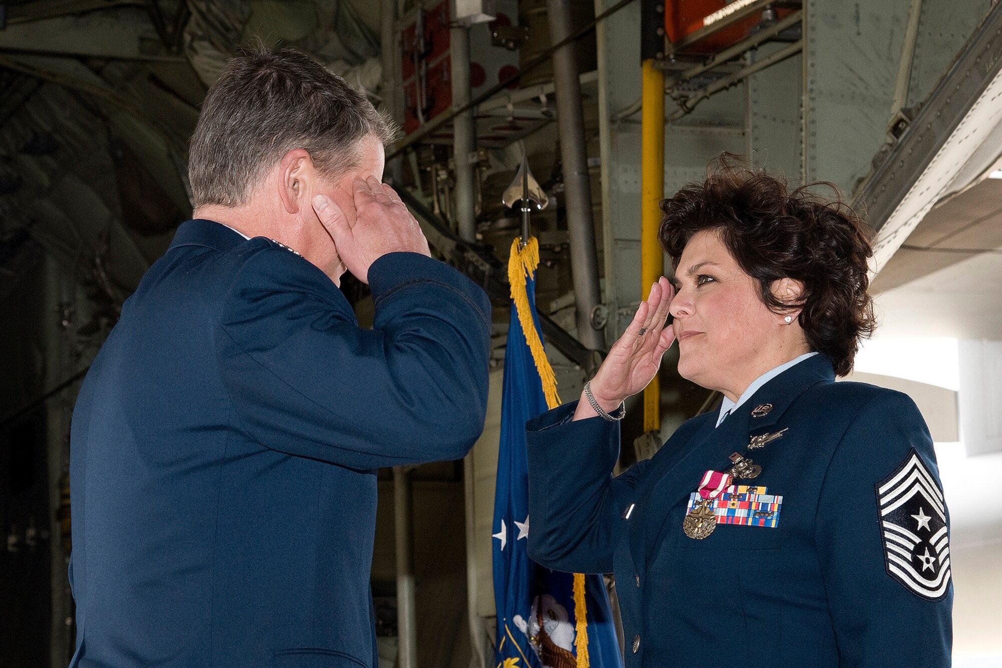 302nd Airlift Wing Command Chief Master Sgt. Suzette Cherry salutes Col. Jay Pittman, commander of the 302nd Airlift Wing after his remarks during her retirement ceremony.  Cherry retired after 25 years of service to the U.S. Air Force during the ceremony held in a 302nd Airlift Wing hangar at Peterson Air Force Base on April 14. (U.S. Air Force photo/Craig Denton)