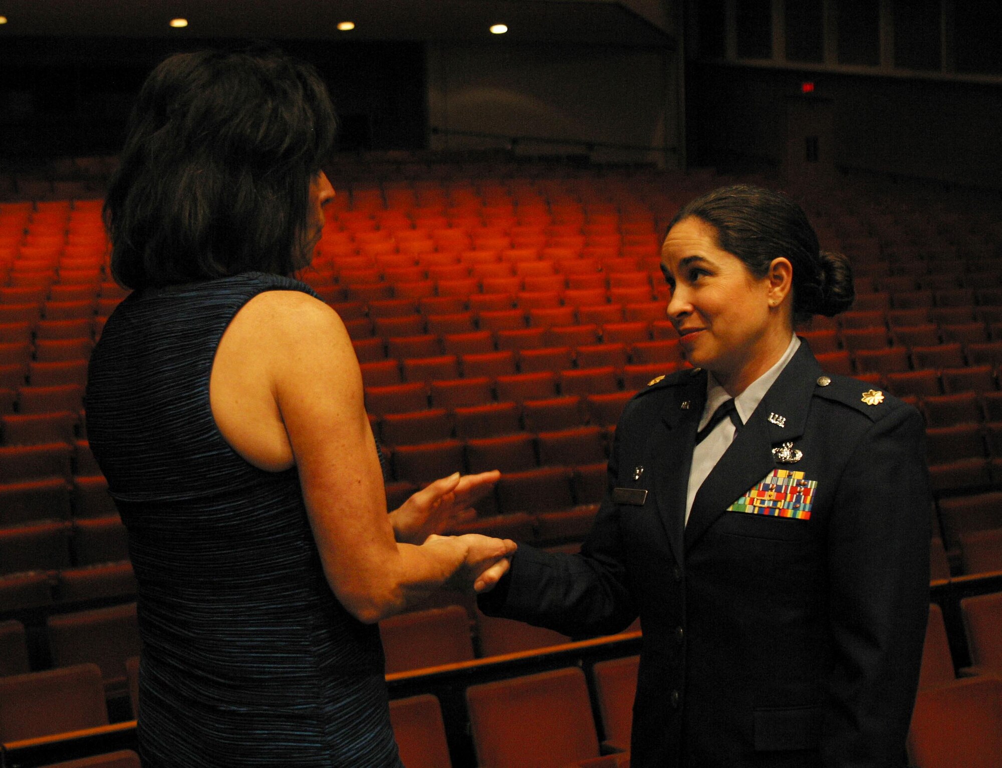 Major Cristina Moore Urrutia, Commander of the Band of Mid-America, shakes the hand of Janine Sija-Rozina, sister of the late POW U.S. Air Force Captain Lance Sijan. Major Moore Urrutia expressed what an honor it was to be able to highlight the accomplishments and legacy of Captain Sijan. Ms. Sijan-Rozina attended the band's concert at Milwaukee’s Marcus Center. (U.S. Air Force Photo by TSgt Keisha Gwin-Goodin)