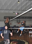 Air Force Intelligence, Surveillance, and Reconnaissance Agency’s Mark Smith, front left, looks on as  teammates Ryan Zimmer and Nate Burney and 737th Training Group’s Warnia Daigle battle at the net. (U.S. Air Force photo/Alan Boedeker)