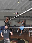 Air Force Intelligence, Surveillance, and Reconnaissance Agency’s Mark Smith, front left, looks on as  teammates Ryan Zimmer and Nate Burney and 737th Training Group’s Warnia Daigle battle at the net. (U.S. Air Force photo/Alan Boedeker)