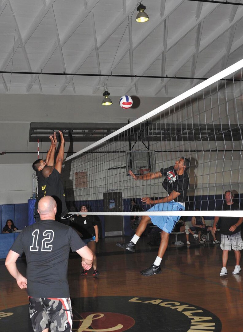 Air Force Intelligence, Surveillance, and Reconnaissance Agency’s Mark Smith, front left, looks on as  teammates Ryan Zimmer and Nate Burney and 737th Training Group’s Warnia Daigle battle at the net. (U.S. Air Force photo/Alan Boedeker)