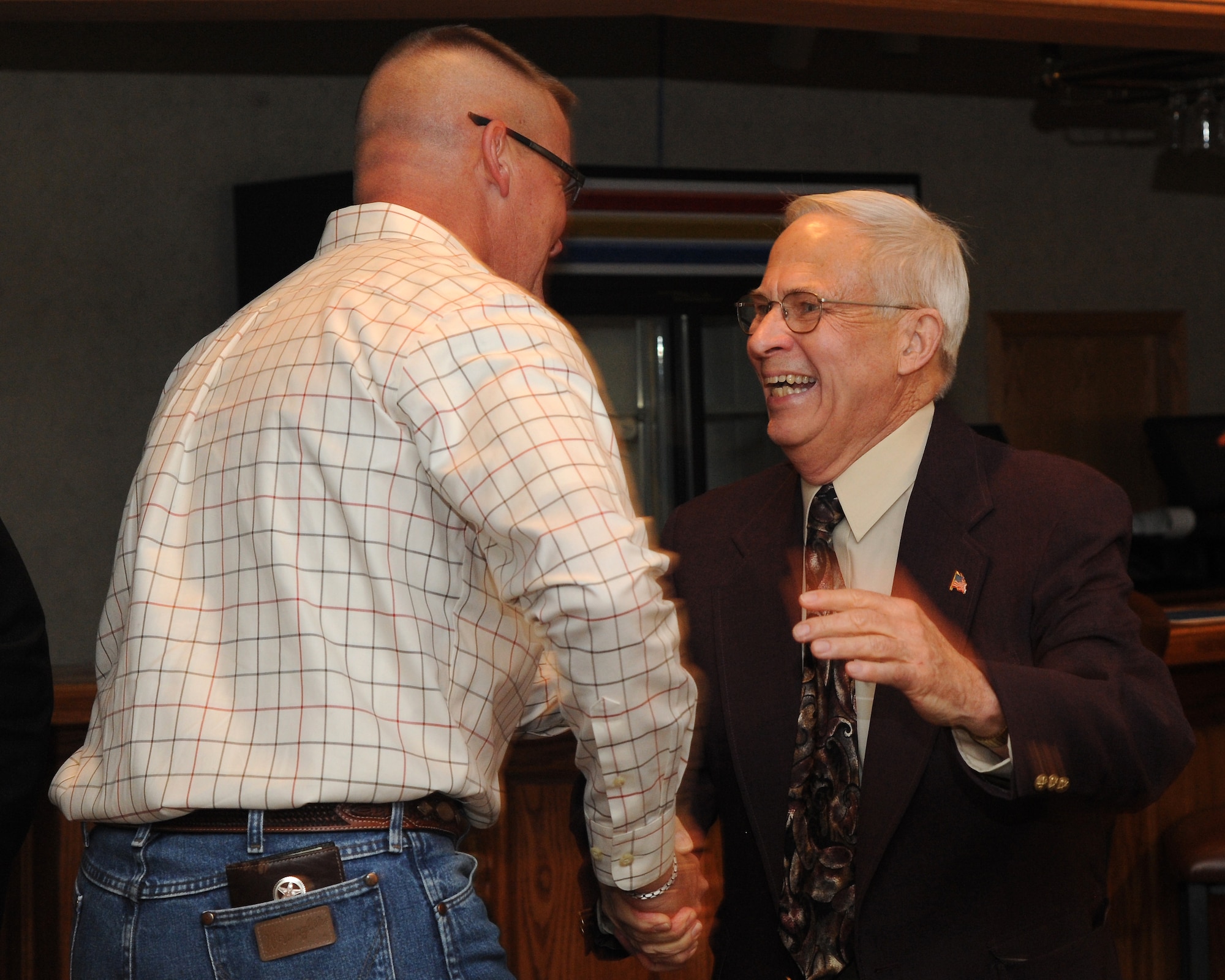Chief Master Sgt. Christopher Crafton, 319th Civil Engineer Squadron, and Jim Bradshaw, honorary ambassador, congratulate each other becoming the newest chief master sergeants on Grand Forks Air Force Base, N.D. during an April 26, 2012, dinner on the base. Bradshaw was named the base’s first-ever honorary chief master sergeant at the dinner. (U.S. Air Force photo by Airman 1st Class Navarro)   