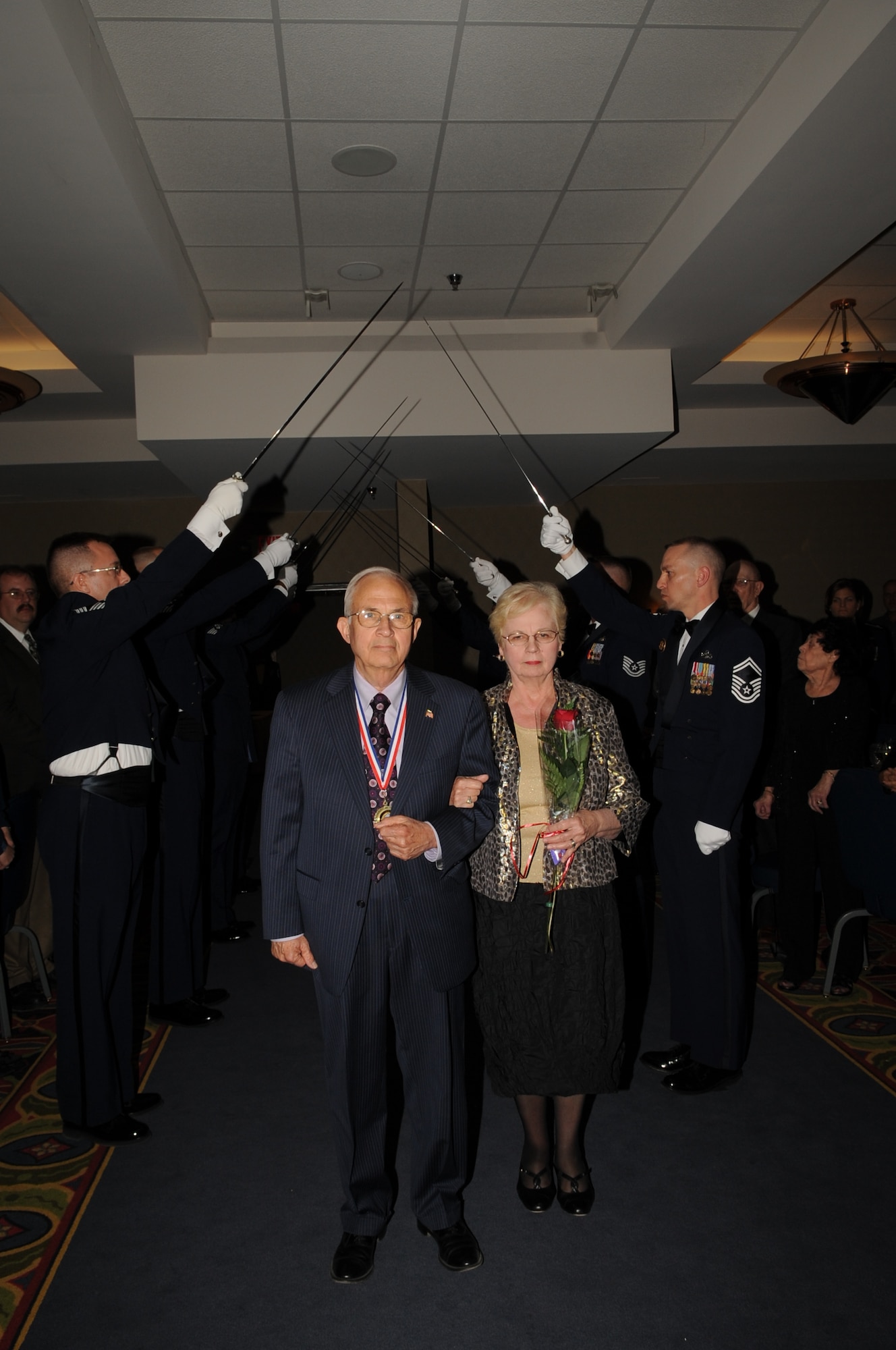 Jim Bradshaw, an honorary ambassador for Grand Forks Air Force Base, N.D., arrives with his wife, Judy, at the Chief’s Recognition Ceremony on April 27, 2012. Bradshaw was named the base’s first-even honorary chief master sergeant during the ceremony. (U.S. Air Force photo by Staff Sgt. Amanda N. Grabiec)