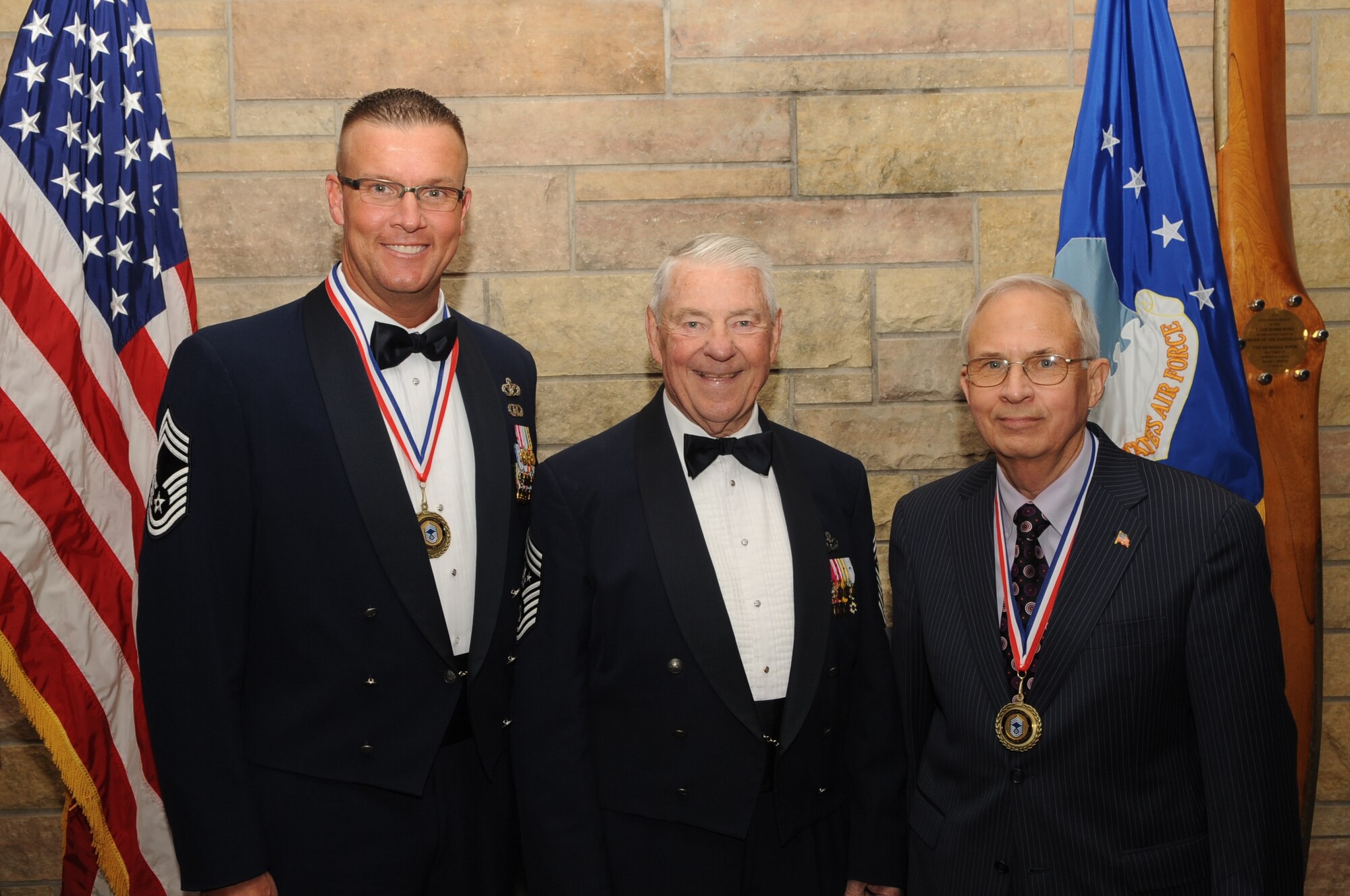 Chief Master Sgt. Christopher Crafton, 319th Civil Engineer Squadron, and Jim Bradshaw, an honorary ambassador for Grand Forks Air Force Base, N.D., pose for a photo with fifth Chief Master Sergeant of the Air Force Robert Gaylor at the Chief’s Recognition Ceremony on April 27, 2012. (U.S. Air Force photo by Staff Sgt. Amanda N. Grabiec)
