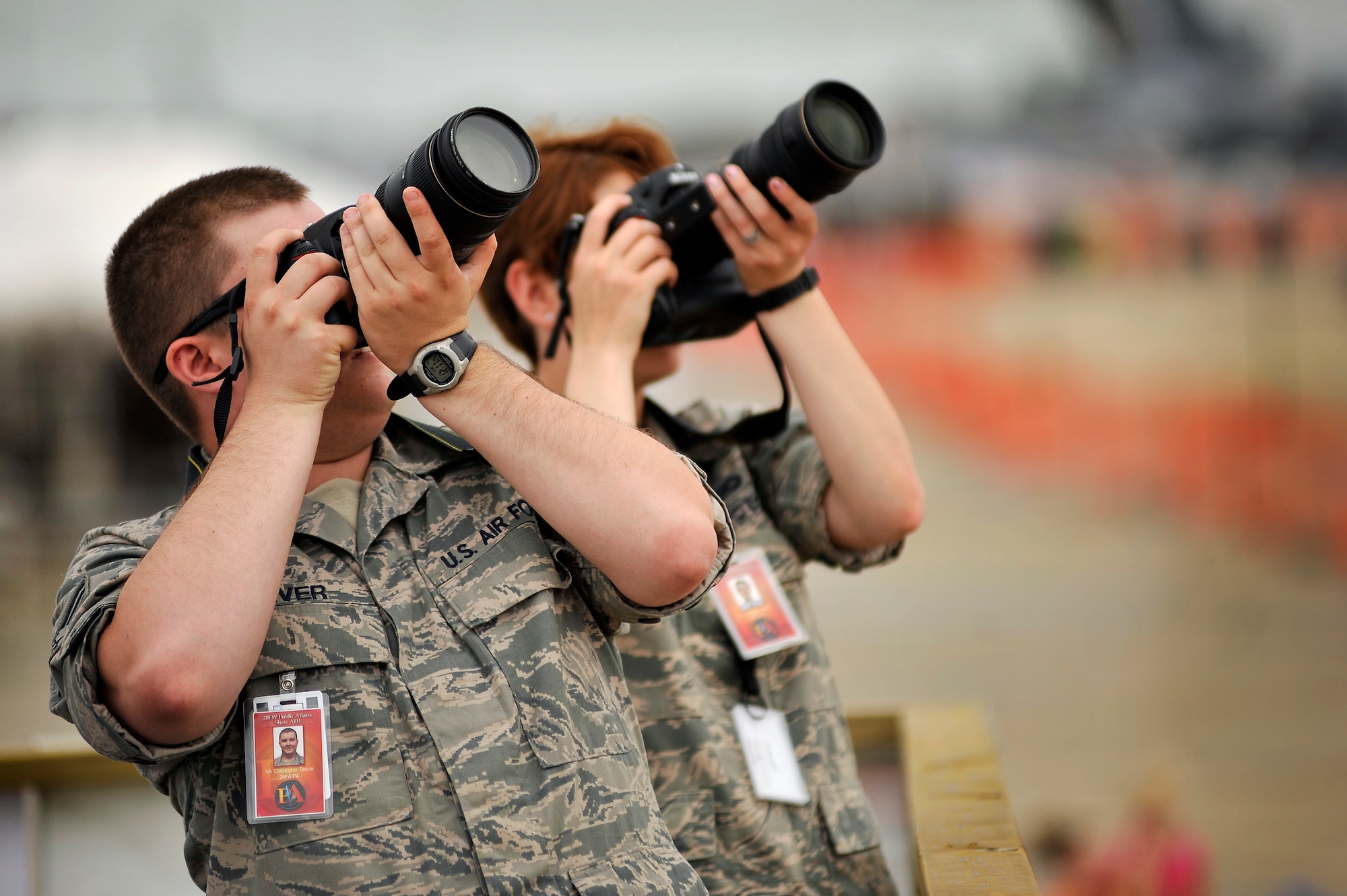 U.S. Air Force Senior Airman Christopher Beaver and Airman 1st Class Krystal Jeffers, both 20th Fighter Wing public affairs, take images of various aircraft performing during day one of the Shaw Air Expo, May 4, 2012, Shaw Air Force Base, SC. The Shaw Air Expo kicked off here today giving military members and their families a chance to witness several aircraft performances. Day 2 and 3 of the Air Expo will take place May 5 through 6 and will be open to the public. (U.S. Air Force Photo by Senior Airman Kenny Holston/Released)


