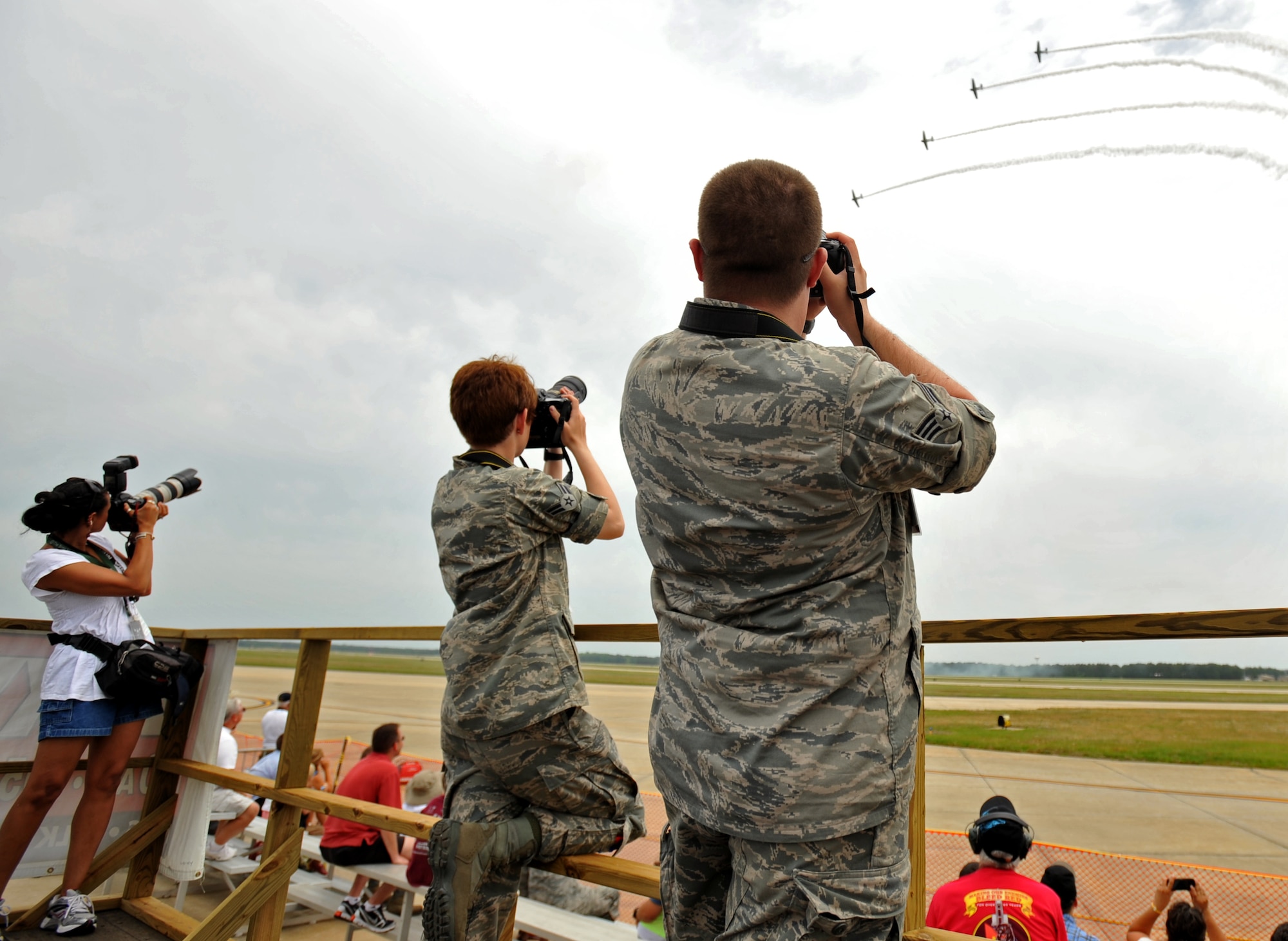 U.S. Air Force Senior Airman Christopher Beaver and Airman 1st Class Krystal Jeffers, both 20th Fighter Wing public affairs, take images of various aircraft performing during day one of the Shaw Air Expo, May 4, 2012, Shaw Air Force Base, SC. The Shaw Air Expo kicked off here today giving military members and their families a chance to witness several aircraft performances. Day 2 and 3 of the Air Expo will take place May 5 through 6 and will be open to the public. (U.S. Air Force Photo by Senior Airman Kenny Holston/Released)


