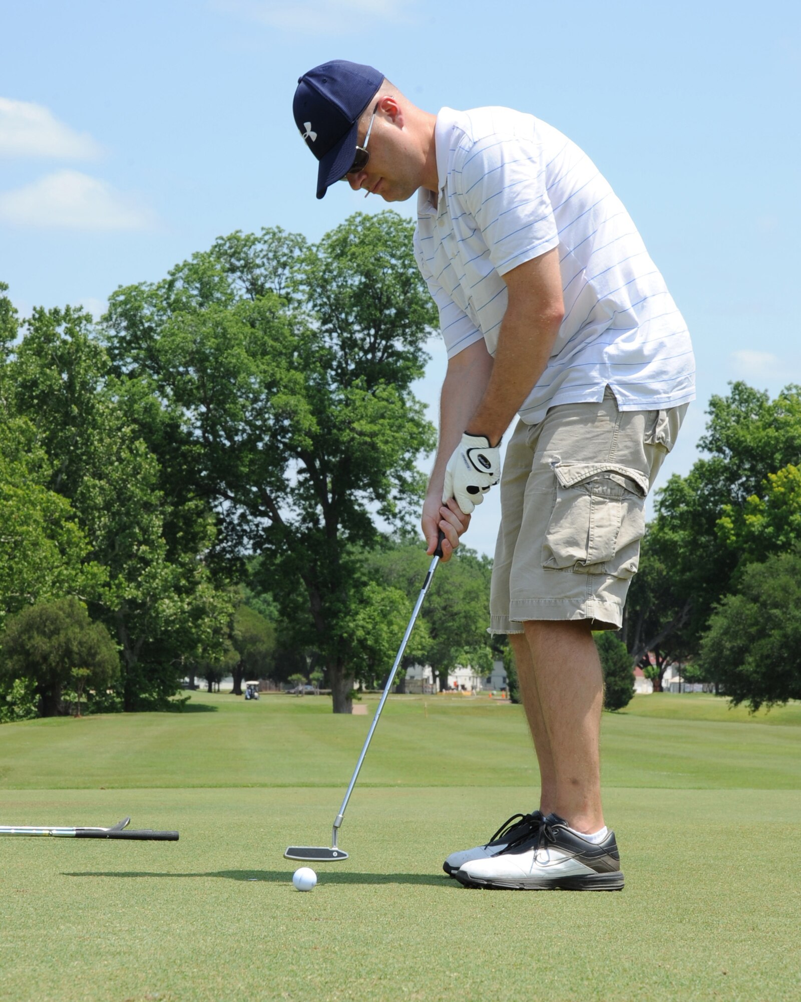 Master Sgt. Justin Swanson, Air Force Global Strike Command A6 plans and policies actions officer, putts a ball during the AFGSC golf tournament on Barksdale Air Force Base, La., May 4. Teams of four competed in the tournament, which was "best ball" format. The top three teams will be awarded gift certificates. (U.S. Air Force photo/Senior Airman Sean Martin)(RELEASED)