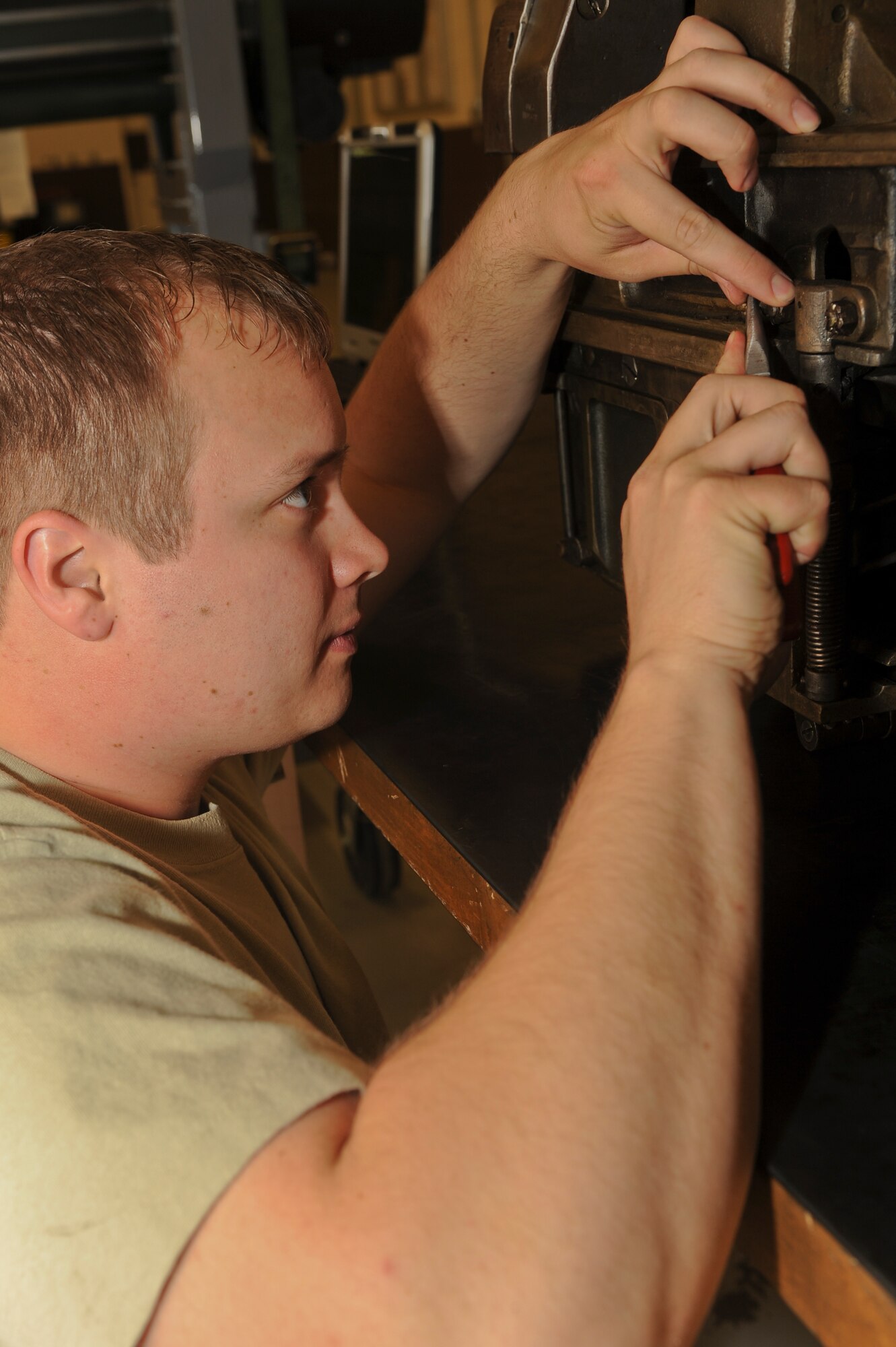 U.S. Air Force Staff Sgt. Ryan Dempsey, 27th Special Operations Maintenance Squadron, tightens a bolt on a 40mm weapon loader in a maintenance facility at Cannon Air Force Base, N.M., May 2, 2012. During maintenance and quality checks, the 40mm weapon loader is inspected for signs of damage.  (U.S Air Force photo by Airman 1st Class Eboni Reece)