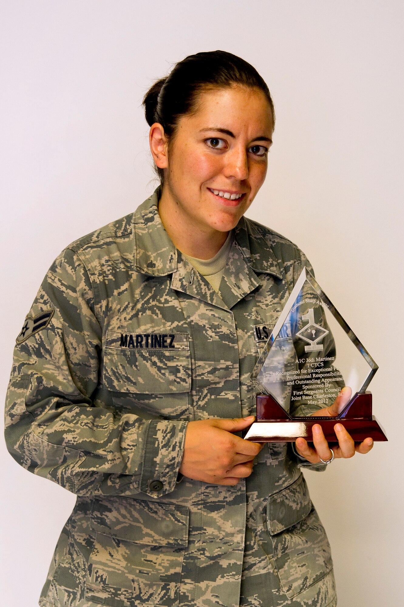 Airman 1st Class Jodi Martinez poses for a photo with her Diamond Sharp
award at Joint Base Charleston May 2. The Diamond Sharp recipients were
Airman 1st Class Jodi Martinez, 1st Combat Camera Squadron, Airman 1st Class
Robert Ealey, 437th Aerial Port Squadron, 437th Airlift Wing, and Senior Airman
Joshua Nelson, 15th Airlift Squadron, 437th AW. The Diamond Sharp
awardees are Airmen chosen by their first sergeants for their excellent
performance. (U.S. Air Force photo/Airman 1st Class George Goslin)
