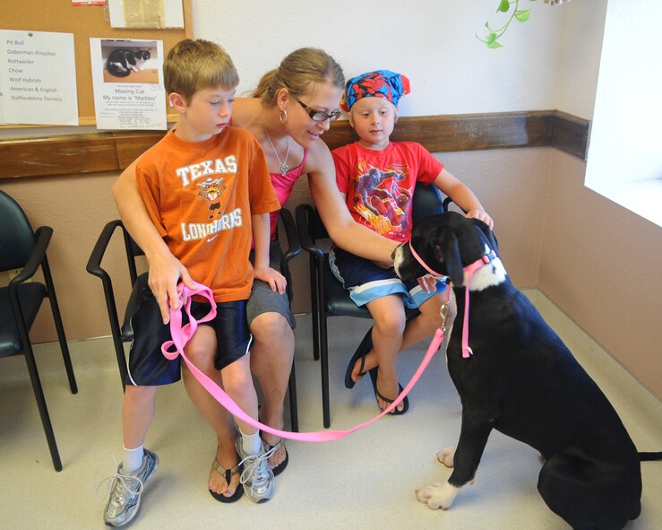 The Banks family sits in the Dyess Veterinary Clinic waiting room with their dog Josie as they wait for their appointment May 2, 2012, at Dyess Air Force Base, Texas. The clinic provides pet services such as: immunizations, treatments for skin disorders, eye and ear infection treatments, micro-chipping, health certificates, and spay and neuter services. Heart worm prevention medication, flea and tick medication, vitamins, dental kits and shampoos are available for purchase at the resale counter. Base housing residents are required to register their pets with the clinic. For more information call the clinic at (325) 696-3366. (U.S. Air Force photo by Airman 1st Class Cierra Bullock/Released)  