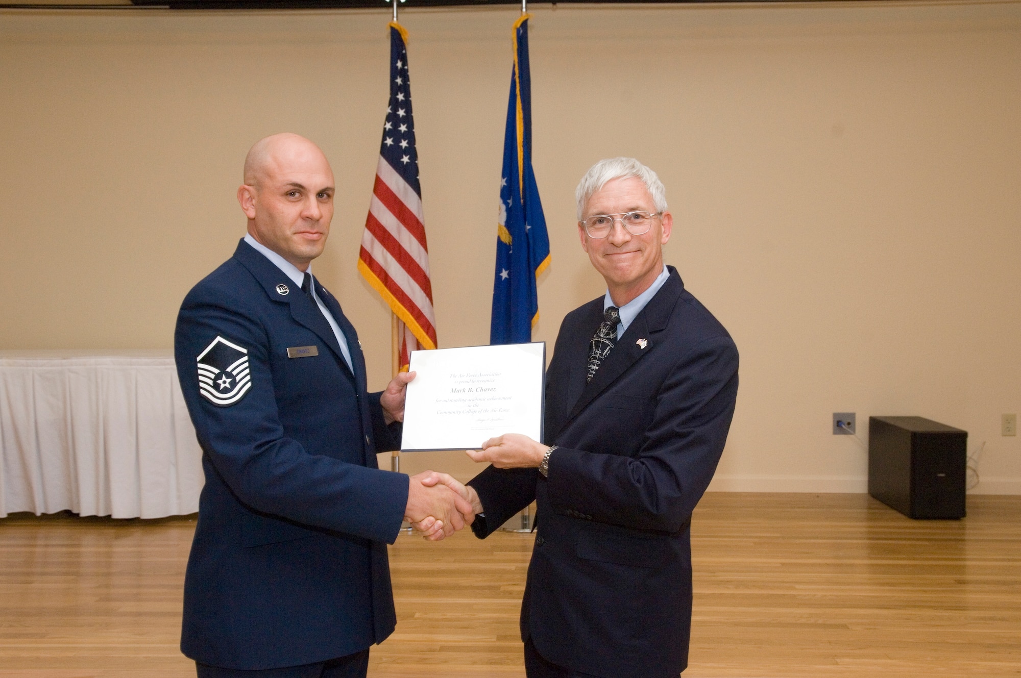 Master Sgt. Mark Chavez, Air Mobility Command Test and Evaluation Squadron Detchment 3, receives his Air Force Association Pitsenbarger Award, which is a monetary award given out to selected Airmen who plan to earn their bachelors degree.  (U.S. Air Force photo by Rob Densmore)