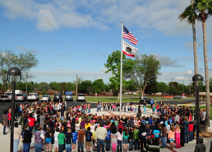 The entire student body from Lone Tree Elementary School at Beale Air Force Base, Calif., gathers around the flag pole to recite the Pledge of Allegiance and sing the National Anthem May 4, 2012. The school gathers here one Friday a month in recognition of Old Glory and to honor members of their families who serve in the armed forces. (U.S. Air Force photo by Senior Airman Shawn Nickel)