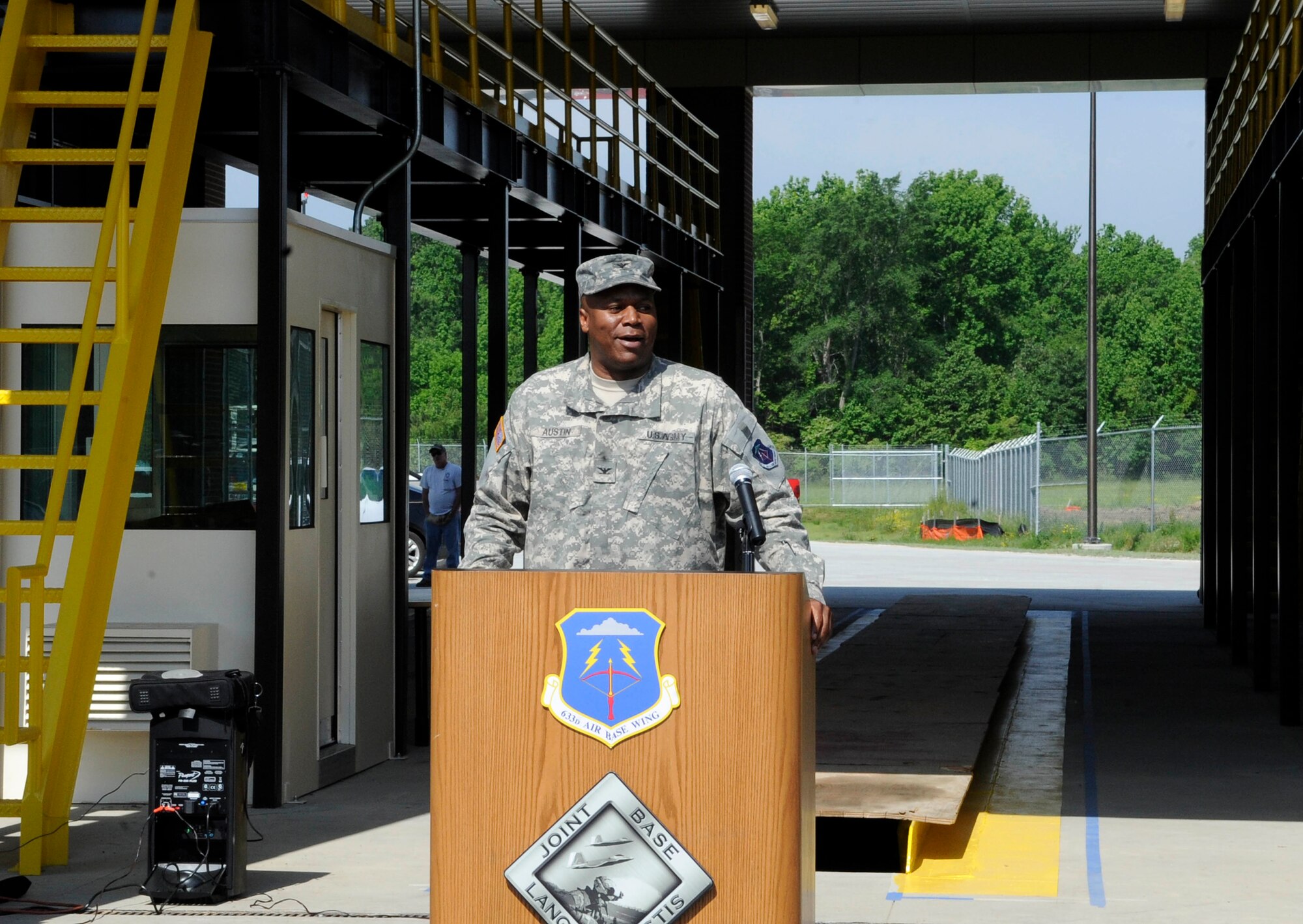 U.S. Army Col Reggie Austin, 633d Air Base Wing vice commander, addresses the crowd during the ribbon cutting ceremony for the Large Vehicle Inspection Station at Langley Air Force Base, Va., May 4, 2012. The LVIS at the West gate is part of a $7.2 million, two-phase project geared toward enhancing security measures on base.  (U.S. Air Force photo by Staff Sgt. Dana Hill/Released)
