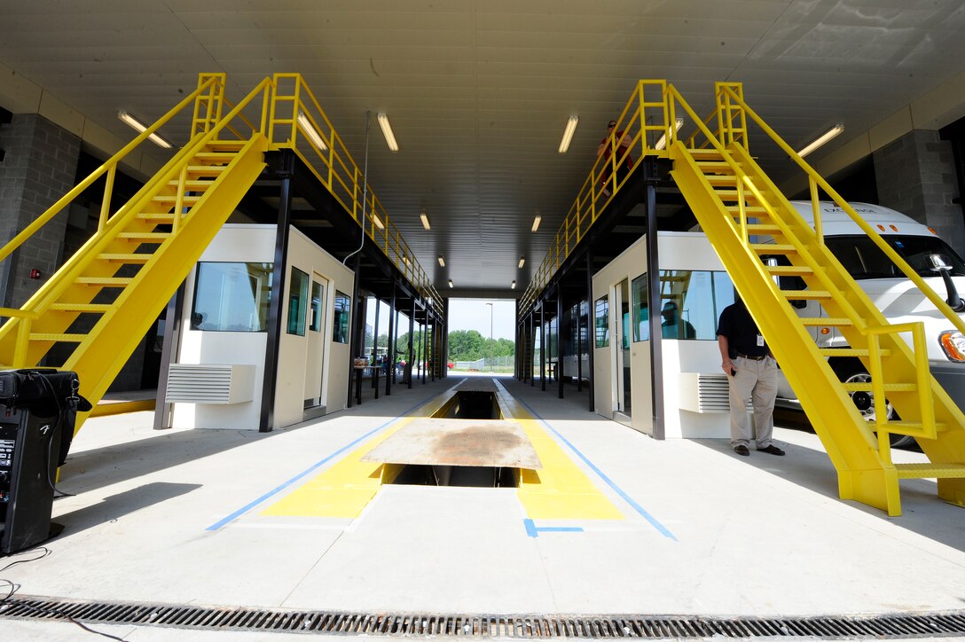 Doors to the new Large Vehicle Inspection Station open after the ribbon cutting ceremony at Langley Air Force Base, Va., May 4, 2012. The new design of the LVIS provides a larger number of entry lanes and generous car stacking space. The LVIS, which is located on Armistead Avenue, officially opened May 7, 2012. (U.S. Air Force photo by Staff Sgt. Dana Hill/Released)