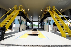 Doors to the new Large Vehicle Inspection Station open after the ribbon cutting ceremony at Langley Air Force Base, Va., May 4, 2012. The new design of the LVIS provides a larger number of entry lanes and generous car stacking space. The LVIS, which is located on Armistead Avenue, officially opened May 7, 2012. (U.S. Air Force photo by Staff Sgt. Dana Hill/Released)
