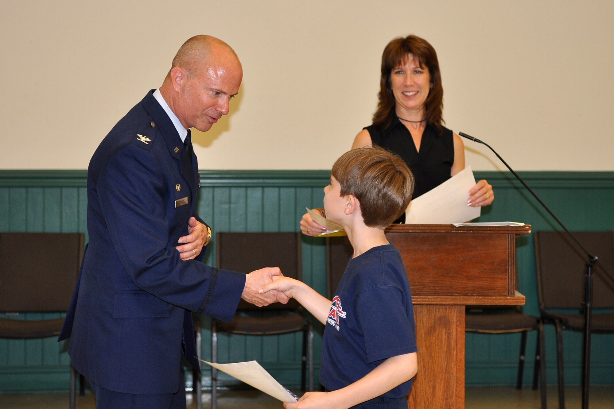 Col. Jon Ellis, commander of the 307th Bomb Wing, Barksdale Air Force Base, La., congratulates a 5th grade student at St. Joseph Catholic School in Shreveport, La., May 3, 2012. Ellis was the guest speaker for a STARBASE graduation ceremony at the school.  The students completed an exciting 25-hour hands on/minds on aviation and aerospace course offered to area 5th grade students and their teachers by STARBASE Louisiana, at Barksdale. The program is one of 60 national STARBASE sites, and is sponsored by the 307 BW of the Air Force Reserve Command. Many U.S. Air Force servicemembers volunteer to speak at the graduation ceremonies to help motivate the students to continue their education. This was Ellis’ first graduation ceremony. Speakers are always welcomed and always needed. Any officer or senior noncommissioned officer interested in motivating these young people should contact the 307th Bomb Wing Public Affairs Office at 318-529-3023 to be put on the speaker’s list. (U.S. Air Force photo by Betty Stephens)