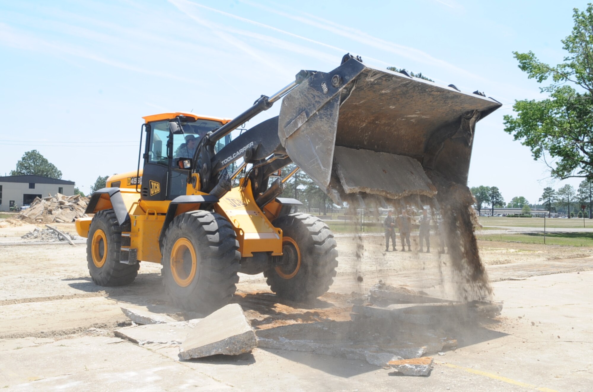 U.S. Air Force Col. Anne Winkler assists Airmen from the 4th Civil Engineer Squadron with removing broken concrete during a construction project in tent city on Seymour Johnson Air Force Base, N.C., May 3, 2012. The goal of this construction project is to make navigating tent city easier for Airmen participating in readiness exercises. Winkler, 4th Mission Support Group commander, is a native of Kansas City, Mo. (U.S. Air Force photo/Airman 1st Class Aubrey Robinson/Released)