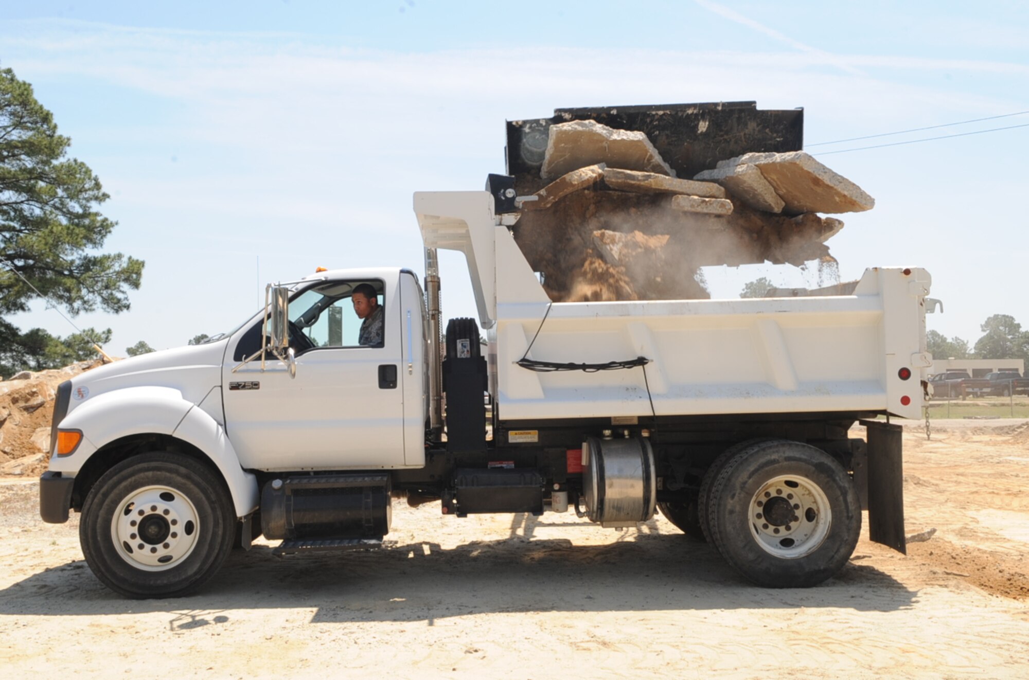 An Airman from the 4th Civil Engineer Squadron removes concrete debris from a construction site in tent city on Seymour Johnson Air Force Base, N.C., May 3, 2012. The degraded concrete in tent city is being replaced to create a safer training environment. (U.S. Air Force photo/Airman 1st Class Aubrey Robinson/Released)