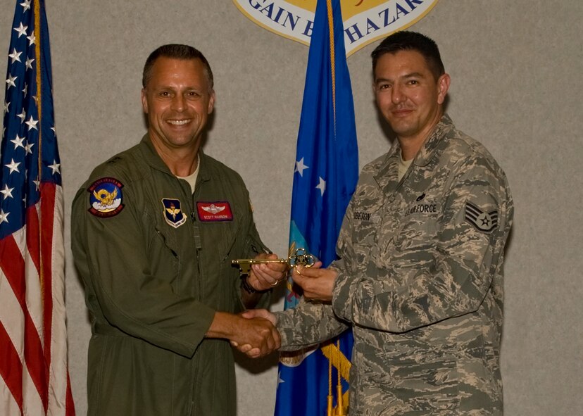 U.S. Air Force Maj. Gen. Scott Hanson, left, Carl A. Spaatz Center of Officer Education commander, presents U.S. Air Force Staff Sgt. Derek Robeson, 317th Aircraft Maintenance Squadron, with the ceremonial key to Dyess’ newest C-130J Super Hercules May 3, 2012, at Dyess Air Force Base, Texas. This is Dyess’ 19th of 28 C-130J Super Hercules to be delivered, replacing the current legacy fleet. (U.S. Air Force Photo by Airman 1st Class Peter Thompson/ Released)