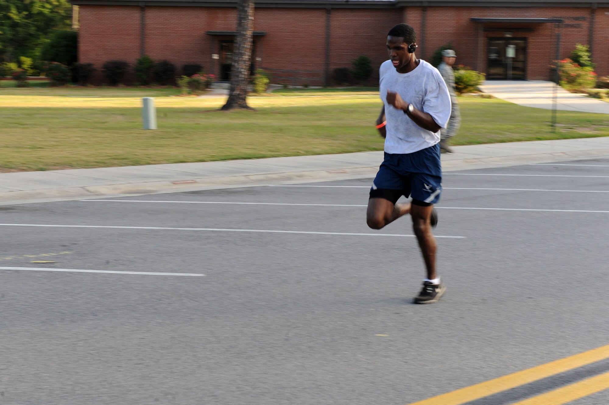 U.S. Air Force Senior Airman Alexander Sims, 23d Communications Squadron, sprints toward the finish line after a Fitness Month 20K run at Moody Air Force Base, Ga., May 4, 2012. The run began at the softball field, extended toward the explosive ordnance disposal compound, past the air traffic control tower and ended at the fitness center. (U.S. Air Force photo by Staff Sgt. Ciara  Wymbs/Released) 
