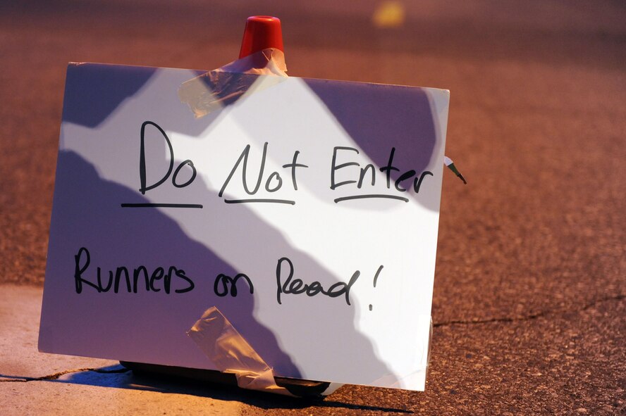 A sign blocks traffic during a Fitness Month 20K run at Moody Air Force Base, Ga., May 4, 2012. This was the first 20K hosted by the Moody fitness center. (U.S. Air Force photo by Staff Sgt. Ciara Wymbs/Released) 