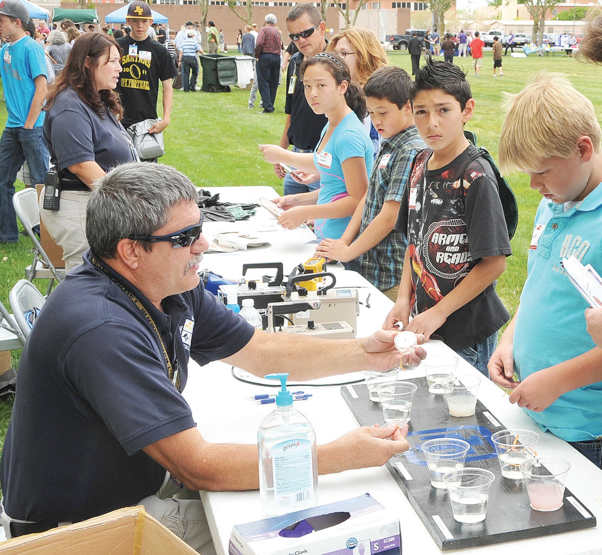KIRTLAND AFB, N.M. -- Eleven-year-old Trevor Johnson, right, takes part in one of several tabletop experiments. (Photo by Todd Berenger)