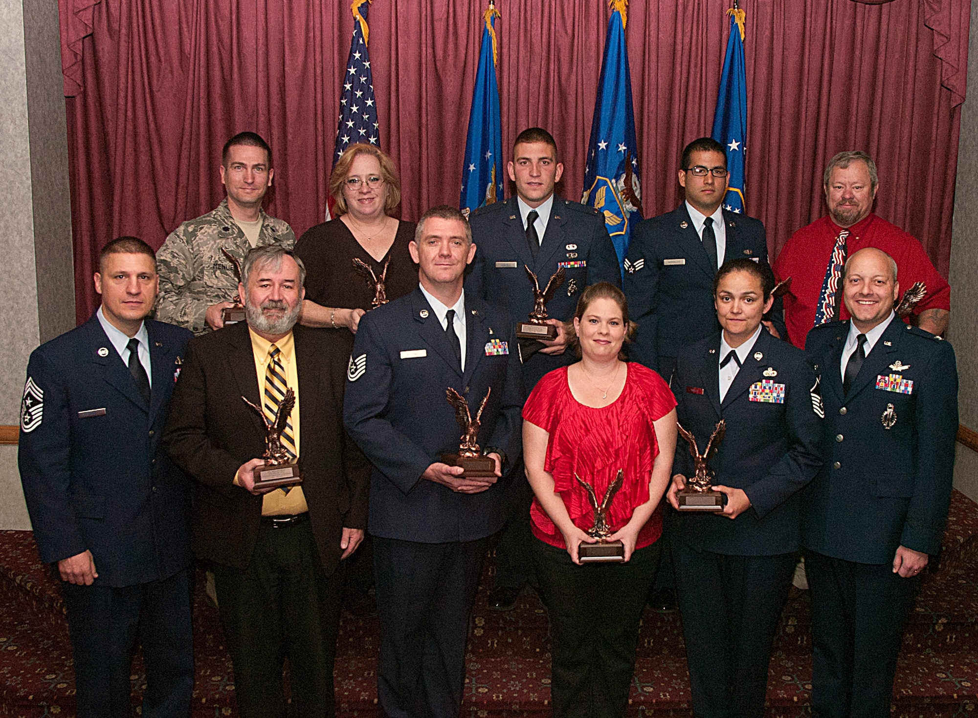 Quarterly award winners of the 90th Missile Wing pose with Col. Christopher Coffelt, 90th MW commander, and Chief Master Sgt. Michael Garrou, 90th MW command chief, following the awards breakfast in the Trail’s End Club April 27. (U.S. Air Force photo by R.J. Oriez)