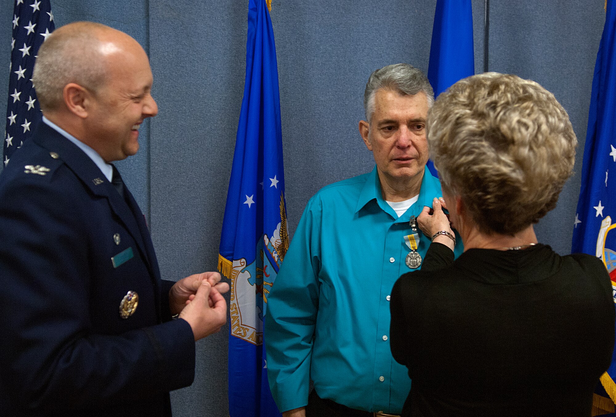 Myra Sprague attaches a retirement pin to her husband, Larry Sprague’s, lapel during his retirement ceremony held in the new base museum April 25. Larry worked as a civilian employee of F. E. Warren for 42 years. Since 2005, Larry was the assistant curator of the Warren Heritage Museum. (U.S. Air Force photo by R.J. Oriez)