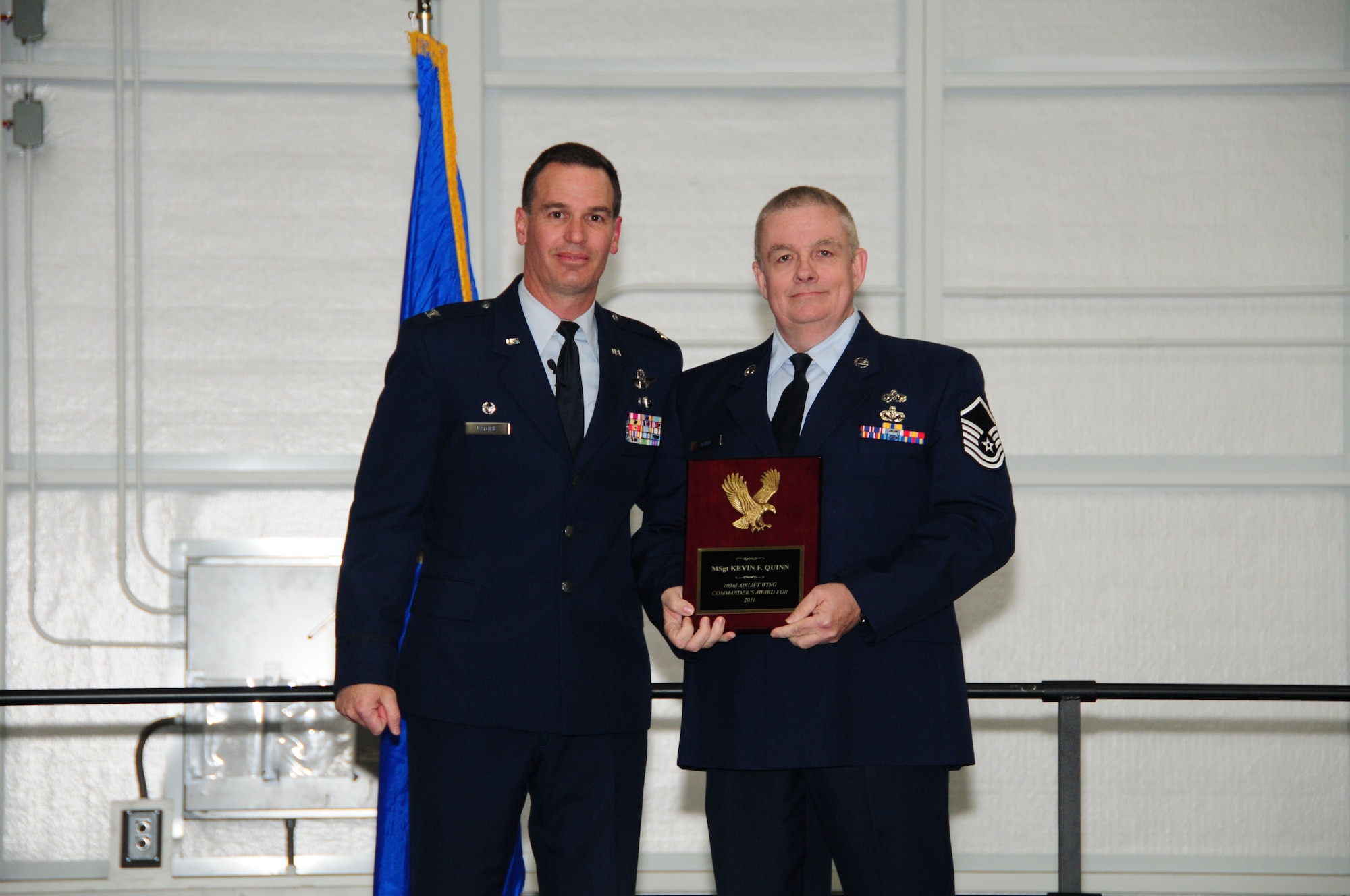 Col. Frank Detorie, 103rd Airlift Wing commander, stands with Master Sgt. Kevin Quinn of the 103rd Civil Engineer Squadron after presenting him with the coveted Commander’s Award during the annual awards ceremony April 14, 2012, in the main hangar at Bradley Air National Guard Base, East Granby, Conn. (U.S. Air Force photo by Senior Airman Emmanuel Santiago\RELEASED)