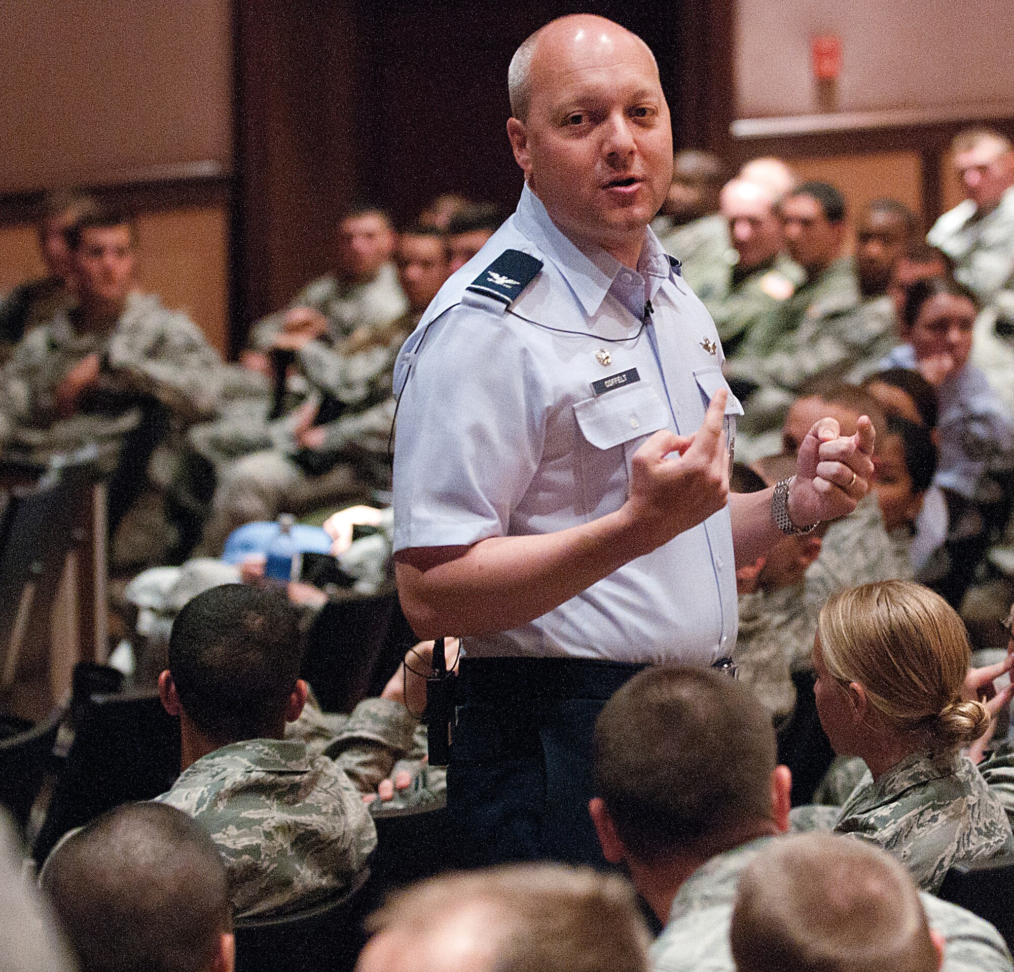 Col. Christopher Coffelt, 90th Missile Wing commander, addresses Airmen of the Mighty Ninety April 23 during one of several commander’s calls held April 23 through 25 in the base theater. During his address to the Airmen, Coffelt discussed risk management and safety during the 101 Critical Days of Summer, sexual assault prevention and response, and Consolidated Unit Inspection preparation. (U.S. Air Force photo by R.J. Oriez)