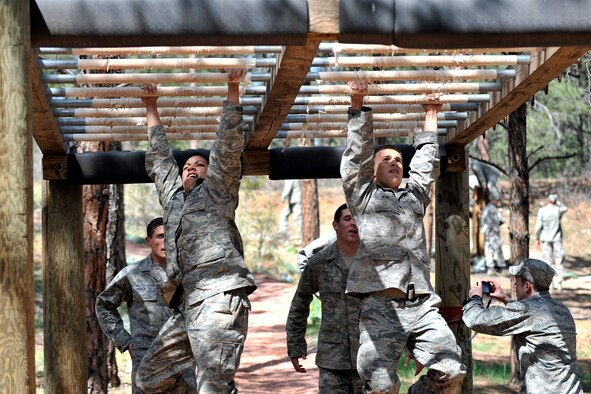 Two cadets in Cadet Squadron 04 navigate the Air Force Academy’s obstacle course in Jacks Valley during the Academy’s inaugural Polaris Warrior challenge Saturday. The event caps a year of military training that may help cadets in the field. (U.S. Air Force photo/Raymond McCoy)