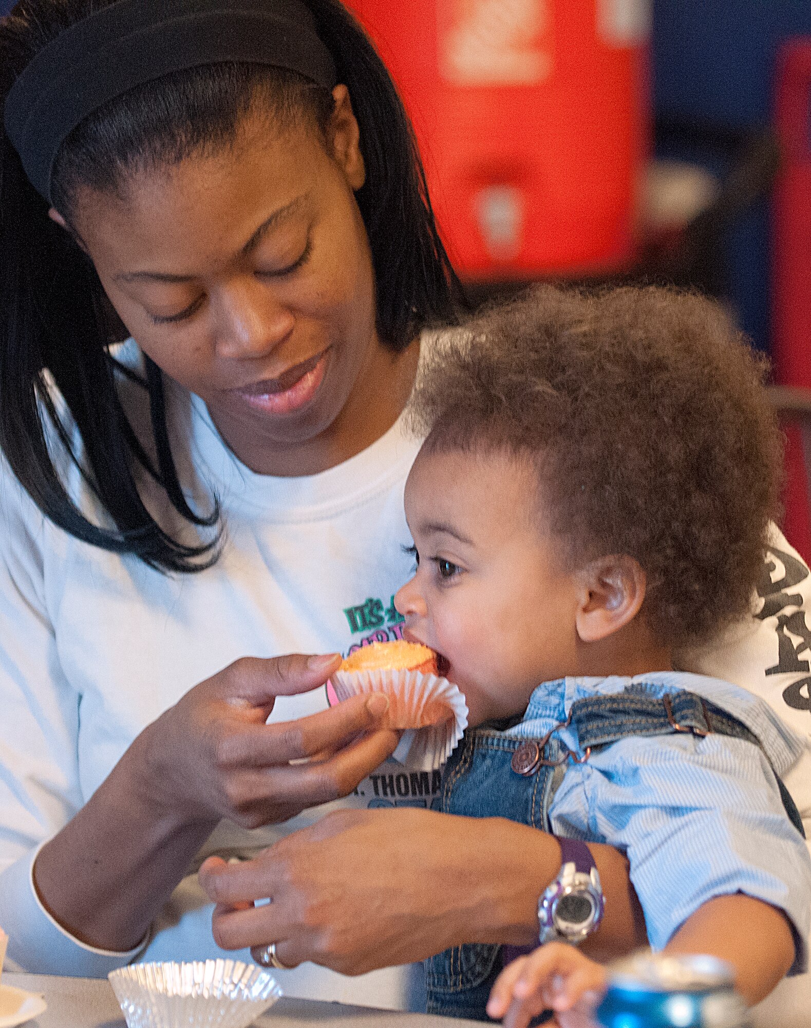 Juanita Rodriguez helps her son Aden, 1, with a cupcake at the F. E. Warren Air Force Base Youth Center’s festivities marking the end of the Month of the Military Child April 27. Aden is also the son of Tech. Sgt. Francisco Rodriquez, 90th Logistics Readiness Squadron.  (U.S. Air Force photo by R.J. Oriez)