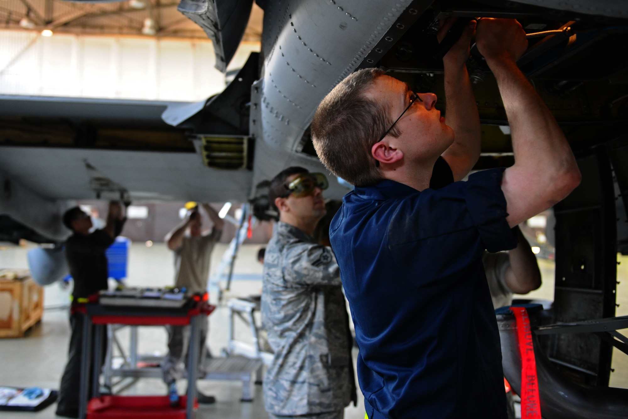 SPANGDAHLEM AIR BASE, Germany – Senior Airman Brandon Spillman, 52nd Aircraft Maintenance Squadron aerospace propulsion journeyman, installs an exhaust on the auxiliary power unit of an A-10 Thunderbolt II during a phase inspection in Hangar 2 here May 4. The phase inspections are separated into two categories. During a phase 1 inspection, the 52nd EMS Maintenance Flight members examine each A-10 after every 500 flying hours, and phase 2 inspections are performed every 1,000 flying hours. These inspections allow the Airmen to check for deficiencies and perform preventative maintenance to ensure the aircraft is safe and operational for flight. (U.S. Air Force photo by Airman 1st Class Matthew B. Fredericks/Released)