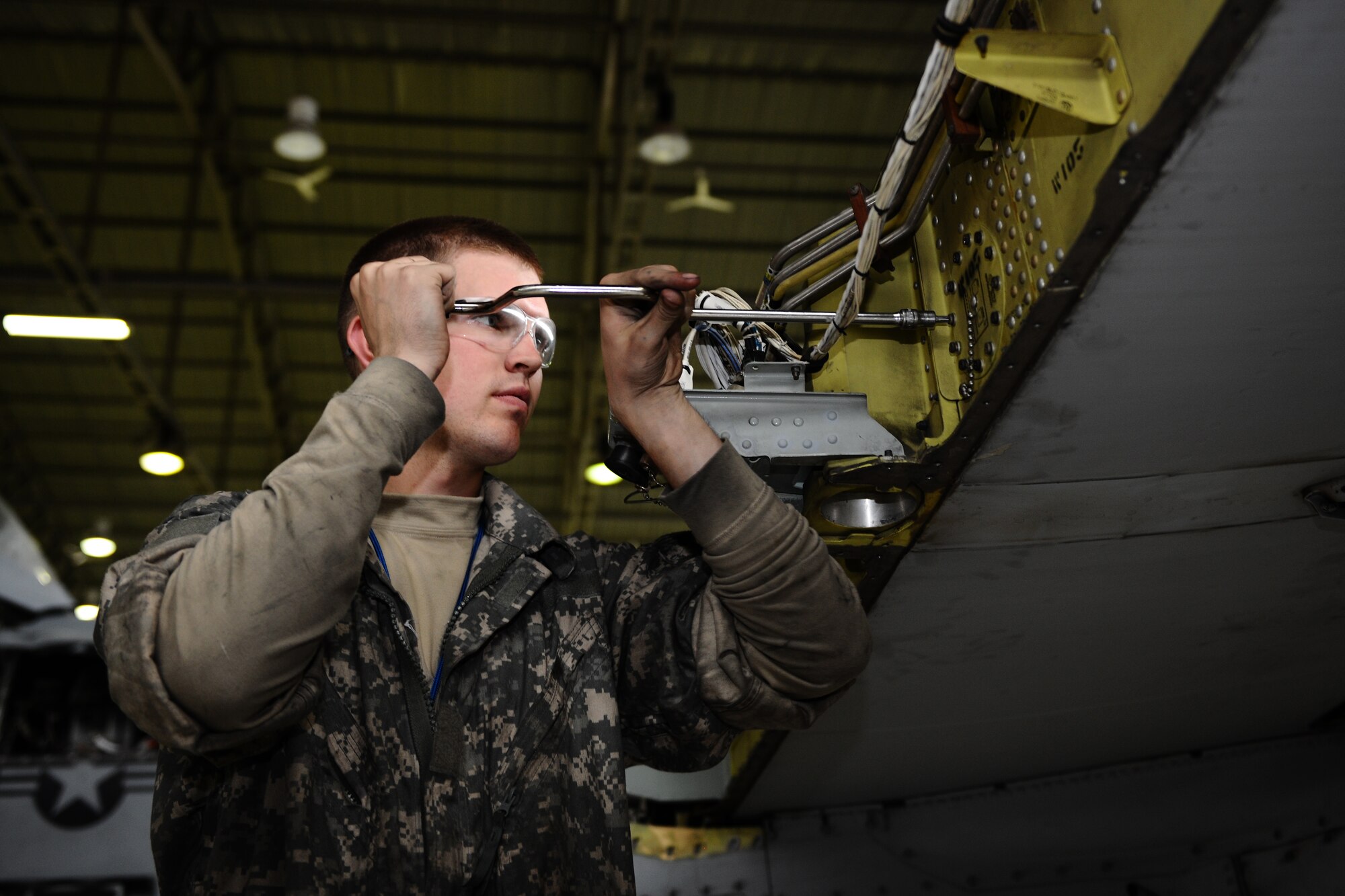 SPANGDAHLEM AIR BASE, Germany – Senior Airman Brian Baker, 52nd Equipment Maintenance Squadron A-10 Thunderbolt II phase technician, works to remove an aileron bracket on the wing of an A-10 during a phase inspection in Hangar 2 here May 4. The phase inspections are separated into two categories. During a phase 1 inspection, the 52nd EMS Maintenance Flight members examine each A-10 after every 500 flying hours, and phase 2 inspections are performed every 1,000 flying hours. These inspections allow the Airmen to check for deficiencies and perform preventative maintenance to ensure the aircraft is safe and operational for flight. (U.S. Air Force photo by Airman 1st Class Matthew B. Fredericks/Released)