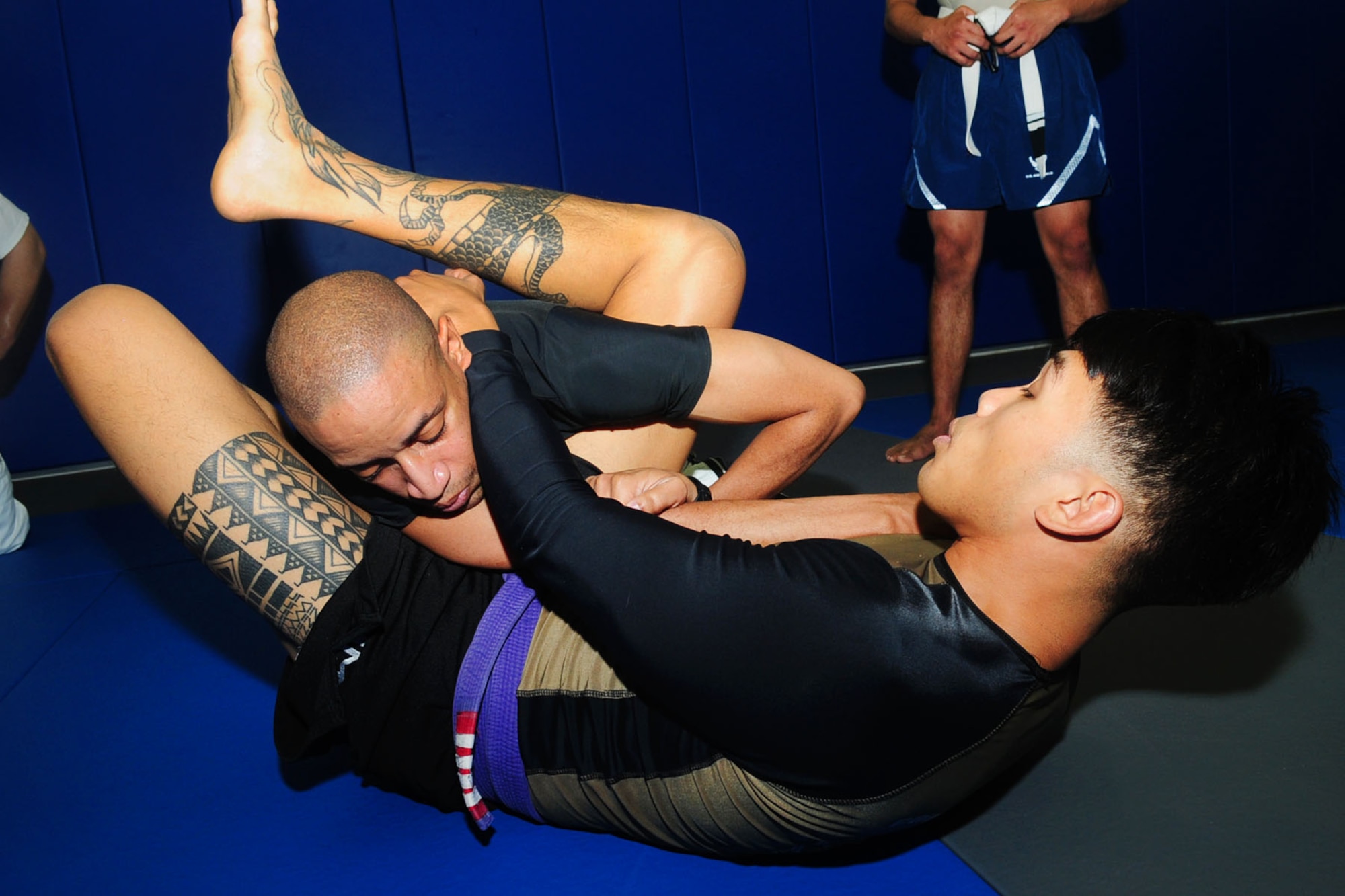 U.S. Air Force Staff Sgt. Christopher Costa, right, 10th Intelligence Squadron link systems technician, traps U.S. Navy Lt. Cmdr. Sidney Martin into a locked arm-bar position during Jui-Jitsu training at Langley Air Force Base, Va., May 1, 2012. Costa, who was introduced to the art in 2006, is the instructor of a Brazilian Jui-Jitsu class at Joint Base Langley-Eustis. (U.S. Air Force photo by Staff Sgt. Ashley Hawkins/Released)