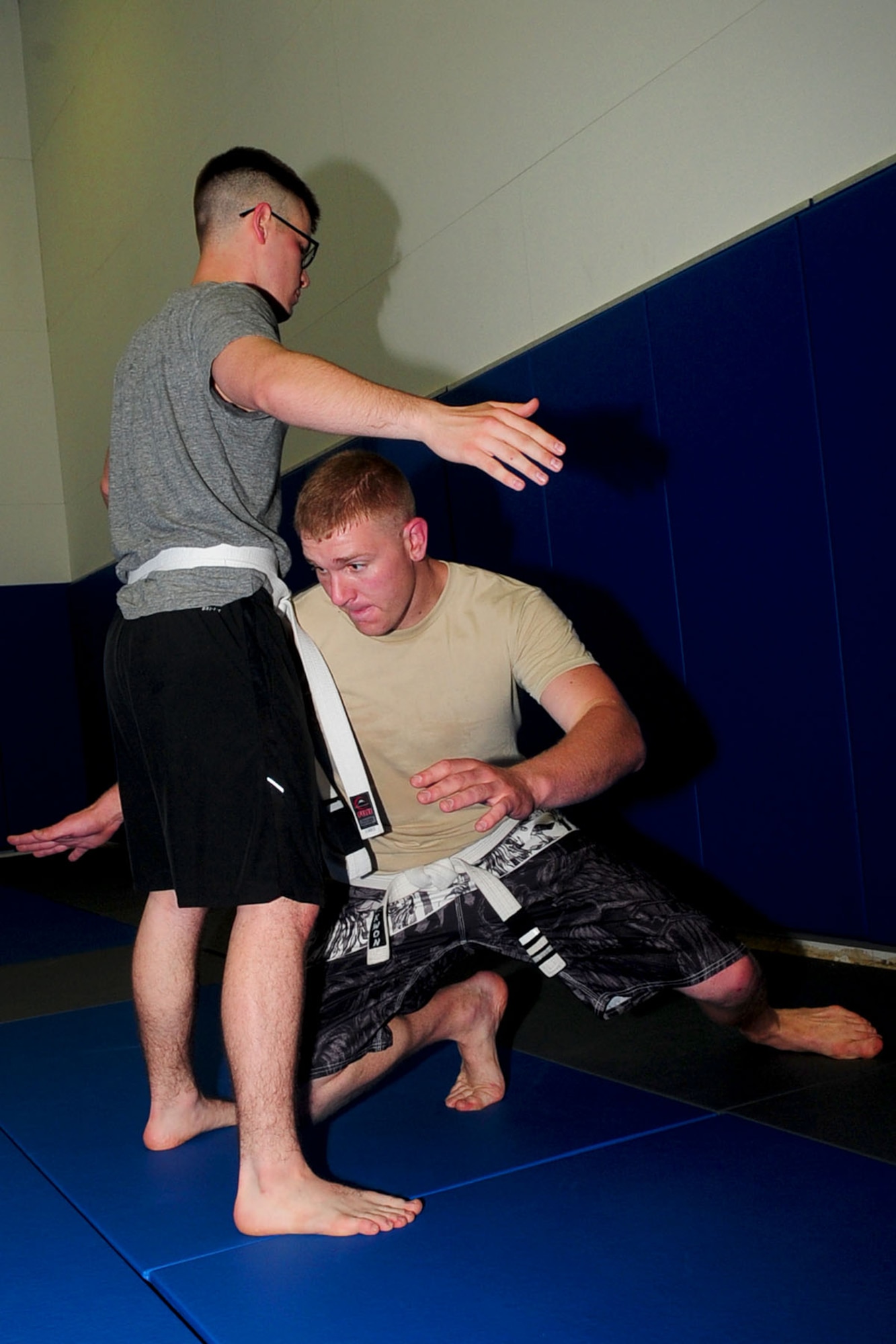U.S. Air Force Airman 1st Class Cole Bonack, left, 633rd Aero Medical Squadron ophthalmic technician, and Senior Airman Shane McNaughton, 1st Maintenance Squadron munitions technician, demonstrate attack and block maneuvering during a Jui-Jitsu class at Langley Air Force Base, Va., May 1, 2012. Brazilian Jiu-Jits, is a self-defense system focused on grappling and ground fighting. (U.S. Air Force photo by Staff Sgt. Ashley Hawkins/Released)