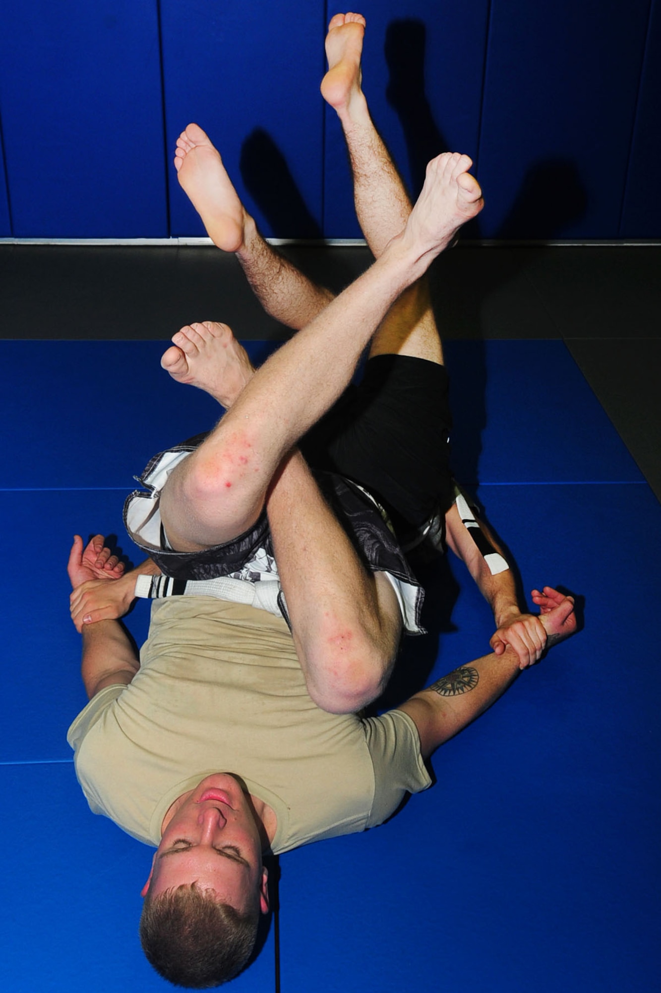 U.S. Air Force Senior Airman Shane McNaughton, 1st Maintenance Squadron munitions technician, and Airman 1st Class Cole Bonack 633rd Aeromedical Squadron, warm up using the high-diamond drill during a Jui-Jitsu class at Langley Air Force Base, Va., May 1, 2012. The Brazilian Jui-Jitsu class is taught by Staff Sgt. Christopher Costa, of the 10th Intelligence Squadron. (U.S. Air Force photo by Staff Sgt. Ashley Hawkins/Released)