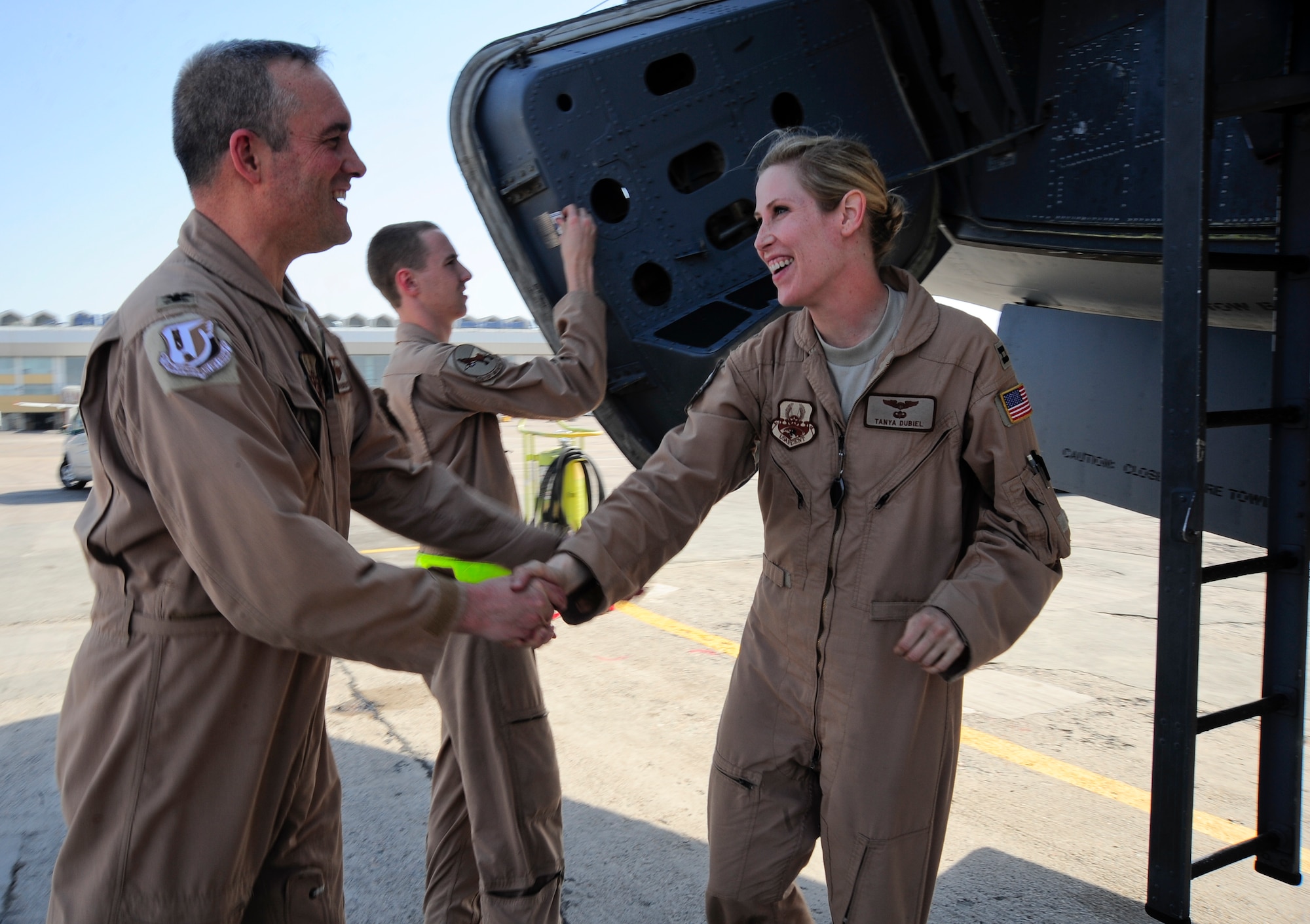Col. Brian Newberry congratulates Capt. Tanya Dubiel on a safe and successful flight which marked the 25,000th mission for the 22nd Expeditionary Air Refueling Squadron May 4, 2012, at Transit Center at Manas, Kyrgyzstan. Newberry is the 376th Operations Group commander who oversees the 22nd EAS. Dubiel is a 22nd EARS KC-135 pilot deployed to the Transit Center at Manas, Kyrgyzstan, from Fairchild Air Force Base, Wash. (U.S. Air Force photo/Staff Sgt. Angela Ruiz)