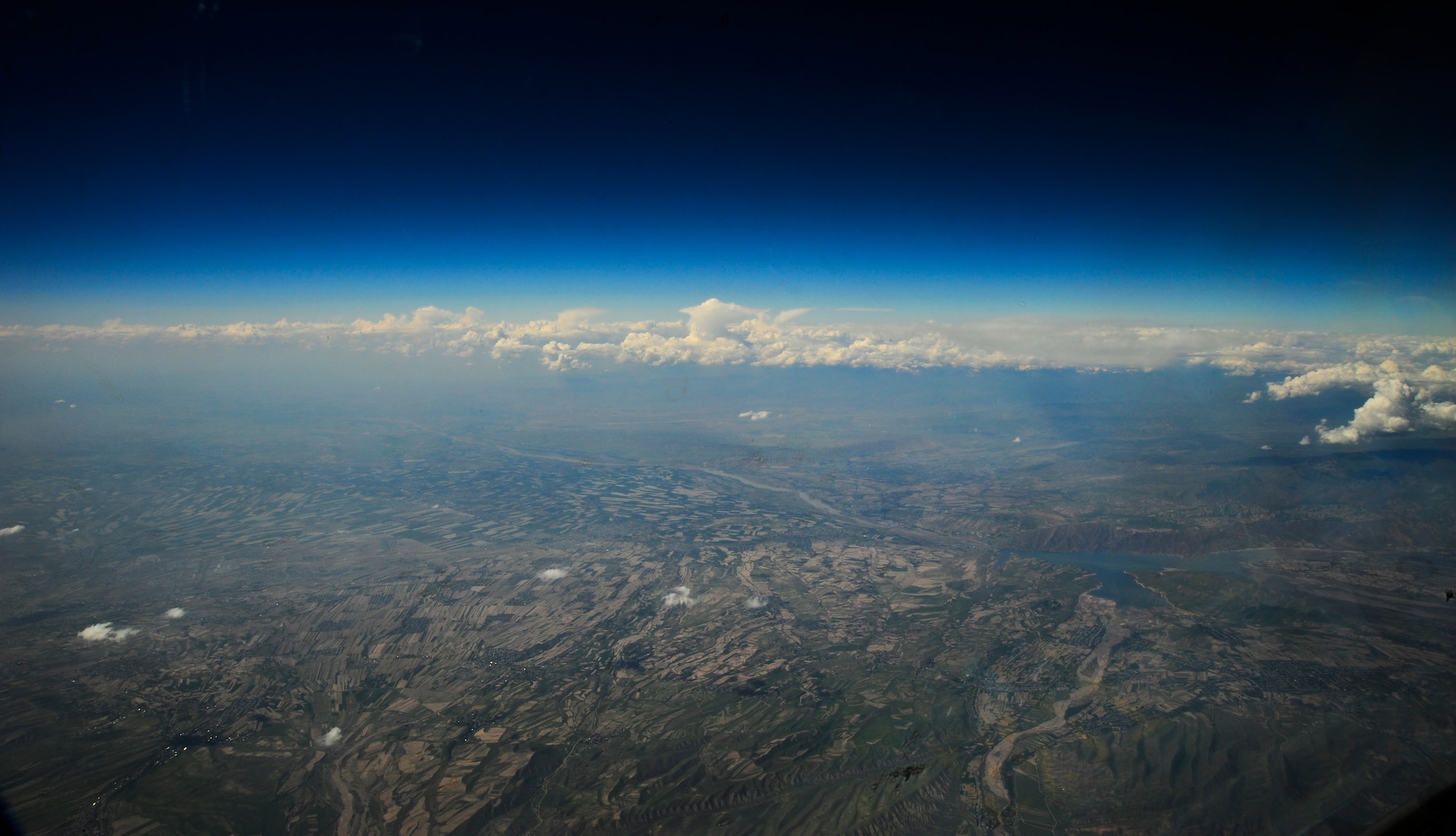 The pilots and aircrew of the KC-135 Stratotanker view the terrain over Afghanistan while traveling to the Transit Center at Manas, Kyrgyzstan, after the 25,000th refueling mission for the 22nd Expeditionary Air Refueling Squadron May 4, 2012. The mission delivered more than 33,000 pounds of fuel to aircraft in support of international efforts in Afghanistan. (U.S. Air Force photo/Staff Sgt. Angela Ruiz)