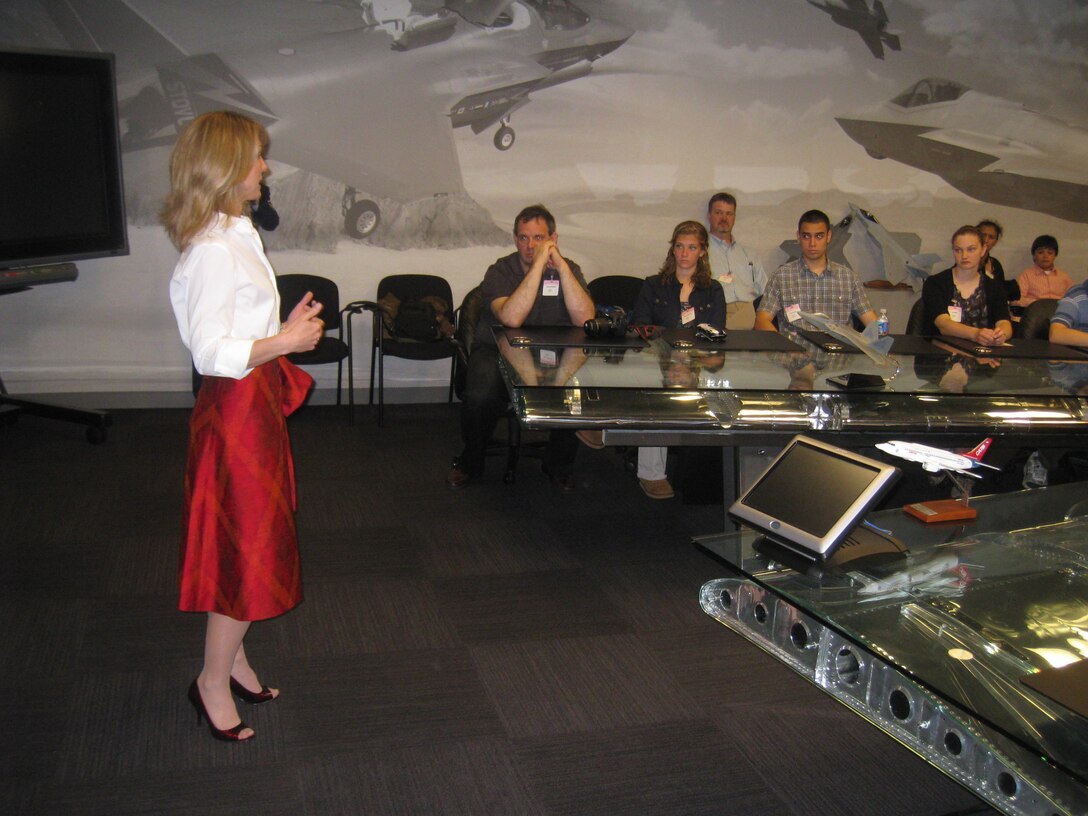 Heather Penney, Air National Gaurd pilot and Lockheed Martin program director, briefs Air Force STEM 2020 winners on Fifth Generation Fighter Technology. The essay winners were there as part of a year-long campaign to energize Virginia, Maryland and Washington D.C. schools supporting careers in science, technology, engineering and math, or STEM.  (Courtesy photo)