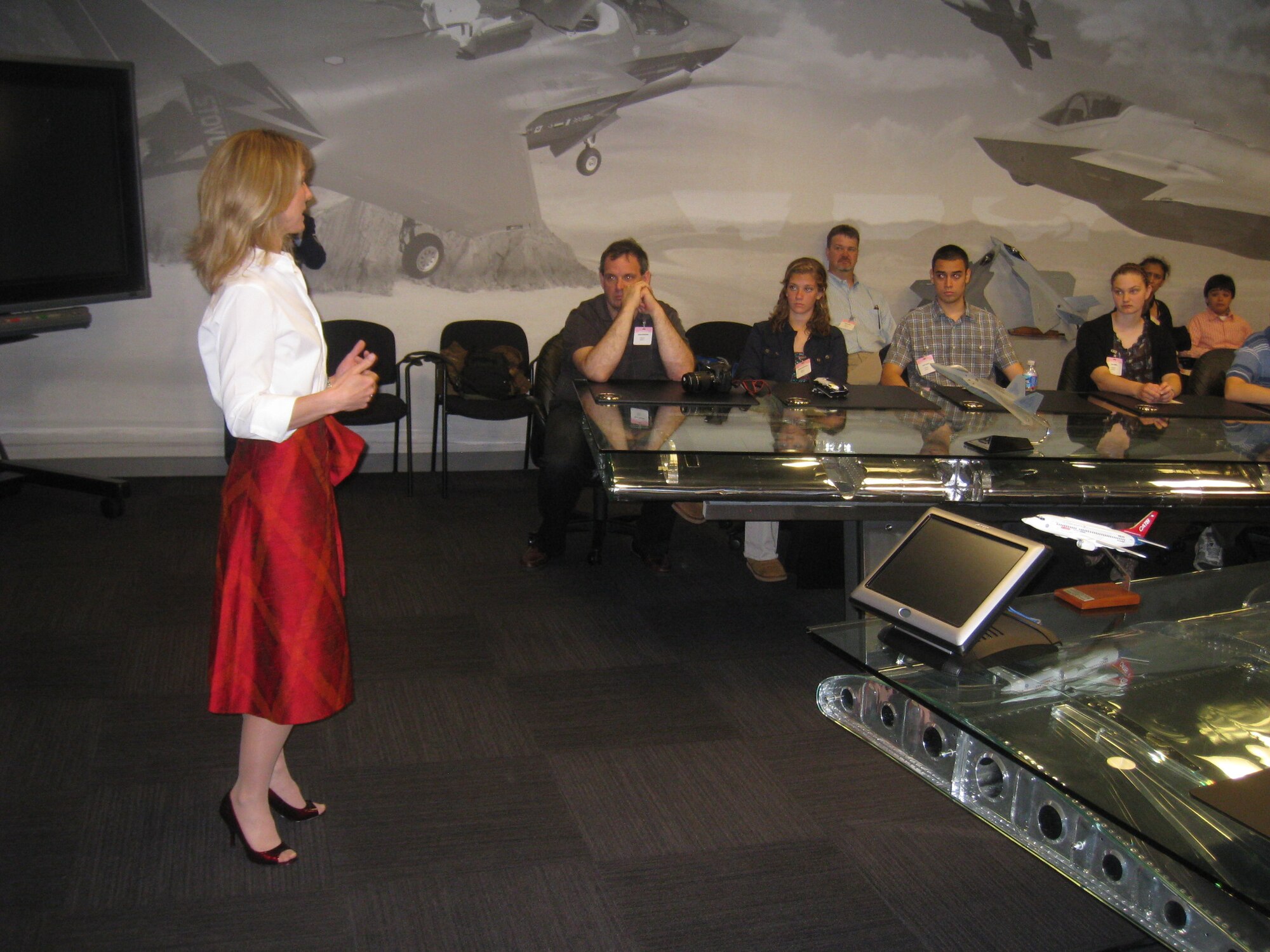 Heather Penney, Air National Gaurd pilot and Lockheed Martin program director, briefs Air Force STEM 2020 winners on Fifth Generation Fighter Technology. The essay winners were there as part of a year-long campaign to energize Virginia, Maryland and Washington D.C. schools supporting careers in science, technology, engineering and math, or STEM.  (Courtesy photo)