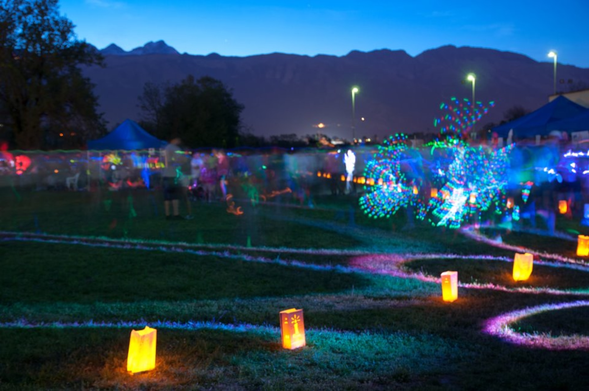 Lit luminary bags stand along side the track for the Luminaria Ceremony during a Relay for Life event April 28 at Aviano Air Base, Italy. During the Luminaria ceremony, people decorate a bag and light a candle inside to honor someone who has faced cancer. This year’s Relay For Life had 16 booths and hundreds of participants, raising more than $14,000 for the American Cancer Society. (U.S. Air Force photo/Tech. Sgt. Rene Aure)