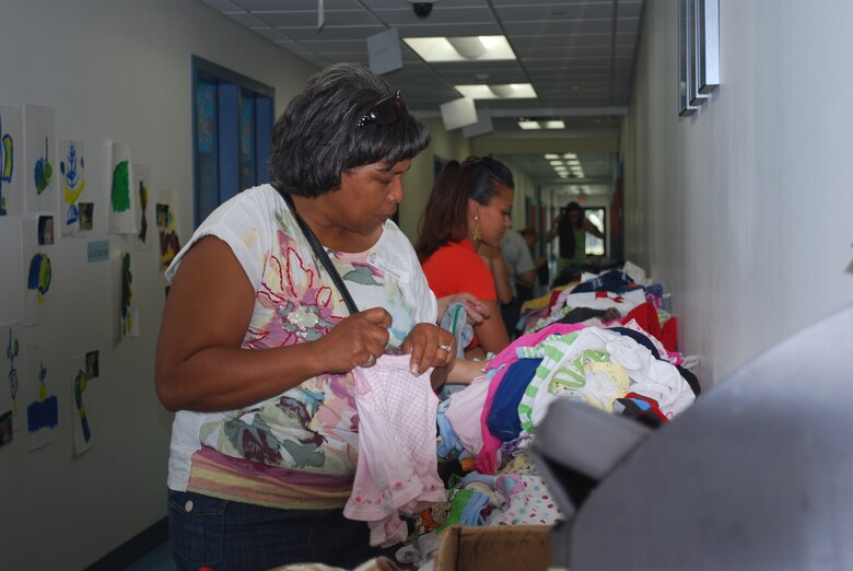 PATRICK AIR FORCE BASE, Fla.  -- Volunteer Alice Frazier, 45th Medical Group, sorts clothes Saturday at the Clothing Swap held in conjunction with the 45th Space Wing's Month of the Military Child festival at the childcare development center. (Photo by Capt Jennifer Lovett, 45th Space Wing Public Affairs)