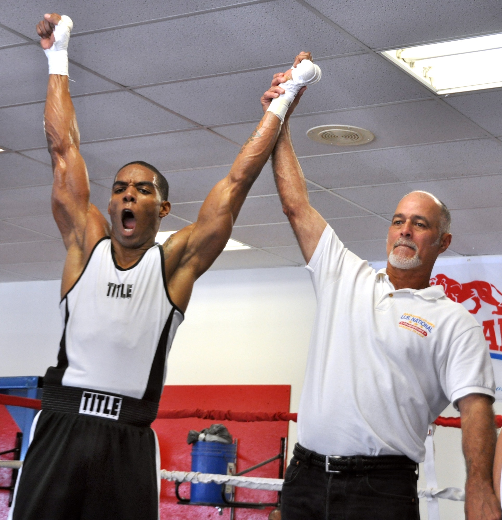 Travis boxer captures win as his hands are raised to show victory