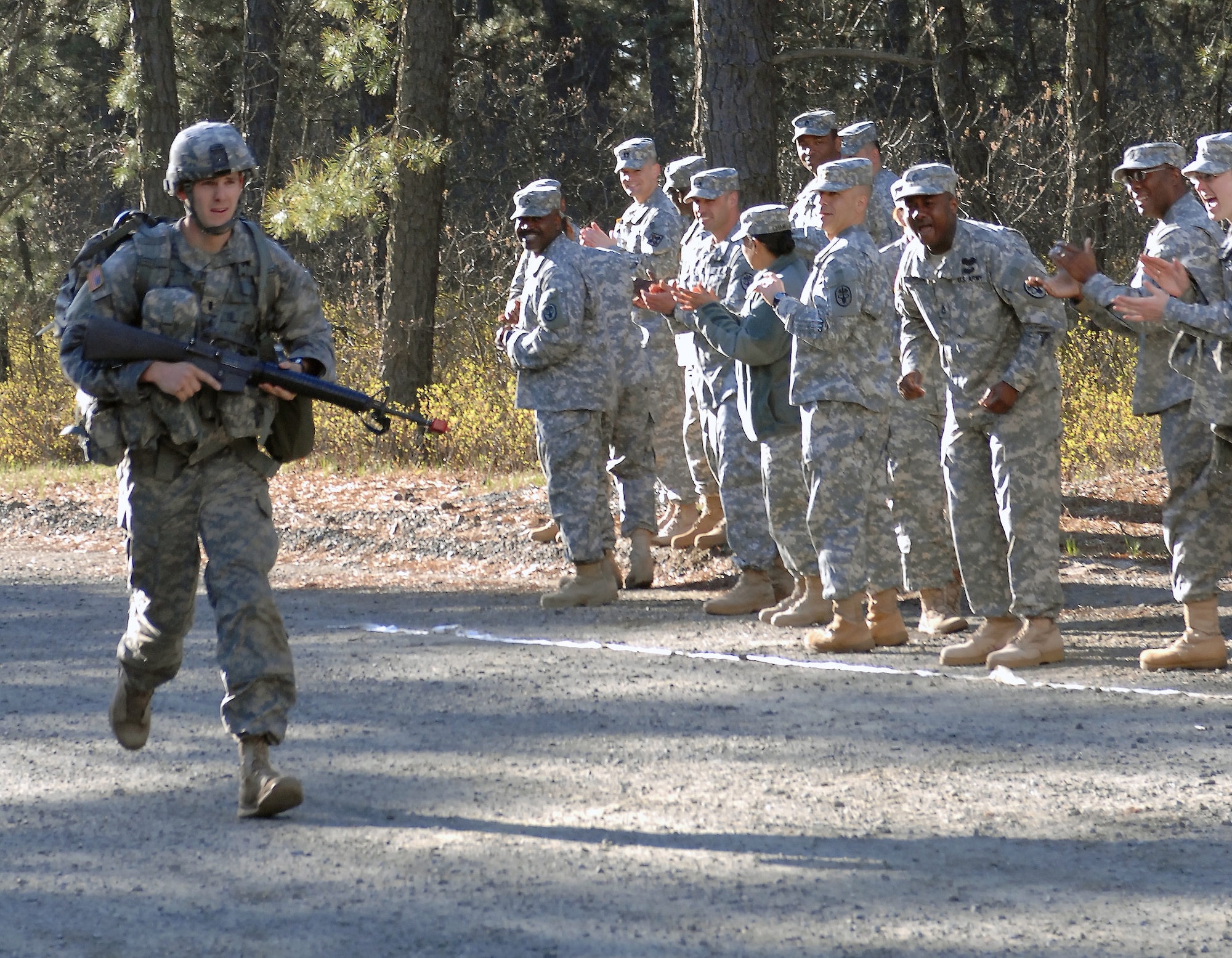 First Lt. Walter Peoples, assigned to Public Health Command Region-North at Fort Meade, Md., is the first to cross the finish line after a 12-mile ruck march April 29, far below the mandated three hour event of the Expert Field Medical Badge Competition, sponsored by U.S. Army's Northern Regional Medical Command headquartered at Fort Belvoir, Va., held at Joint Base McGuire-Dix-Lakehurst. (U.S. Army courtesy photo/Released)