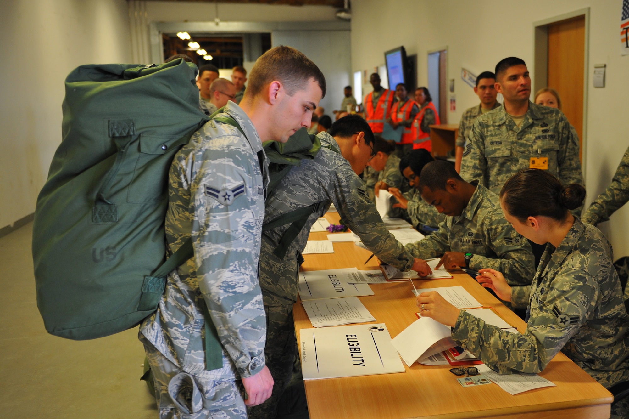 SPANGDAHLEM AIR BASE, Germany – Airmen stand in a personnel deployment function line during a Phase I readiness exercise inside Bldg. 103 here May 3. The line ensures Airmen get required medical, financial, legal, spiritual and media support before they leave for a deployment. The exercise ensures the 52nd Fighter Wing is prepared to win today’s fight by delivering precise, reliable and ready full-spectrum capabilities. (U.S. Air Force photo by Airman 1st Class Dillon Davis/Released)