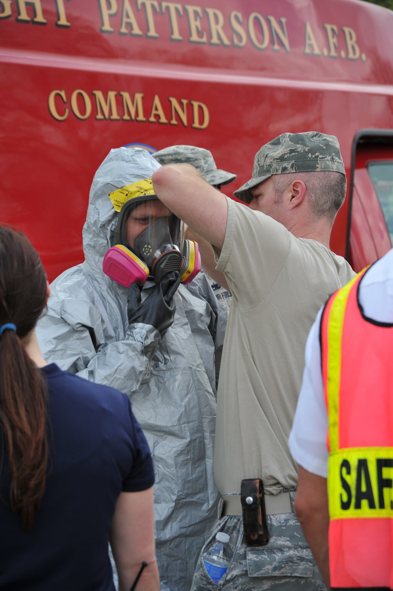 Staff Sgt. Daniel Thorton (right), 88th Aerospace Medicine Squadron Bioenvironmental Engineering Flight, assists Staff Sgt. David Miller in
donning a Level C Protective Suit during a hazardous material incident
response exercise May 2.  The scenario involved response to an attack with
an improvised radiological disbursal device and resulted in extended
lockdown of base gates during Force Protection Condition FPCON Delta. (U.S.
Air Force photo/Ben Strasser)   

