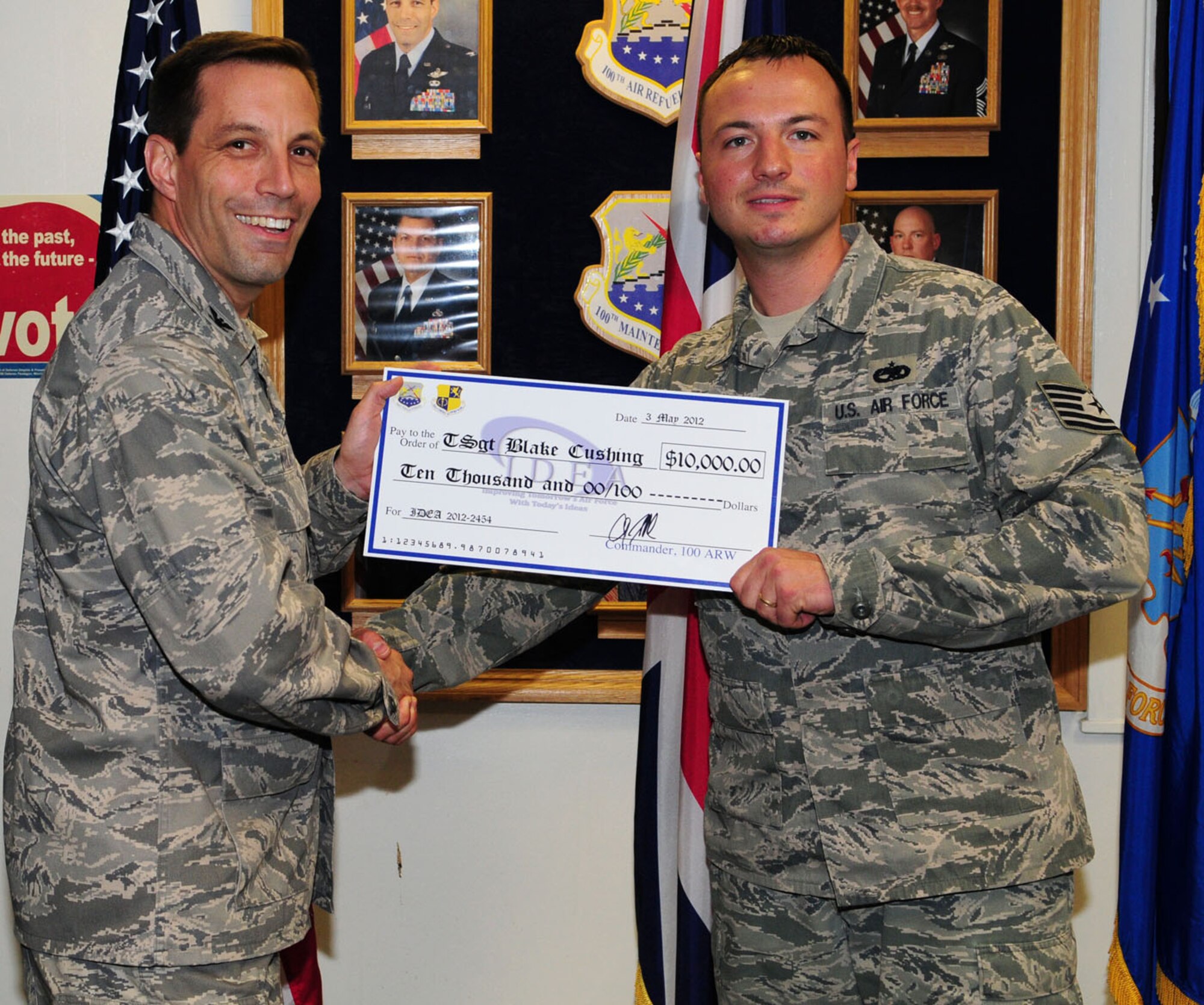 RAF MILDENHALL, England – Col. Christopher Kulas, 100th Air Refueling Wing commander, presents a “check” to Tech. Sgt. Blake Cushing, 100th Aircraft Maintenance Squadron, May 3, 2012, at Bldg. 809. Cushing was awarded $10,000 through the Innovative Development through Employee Awareness program recently, when he came up with an idea that was researched and proven to save the Air Force more than $132,000 per year.  (U.S. Air Force photo/Karen Abeyasekere)